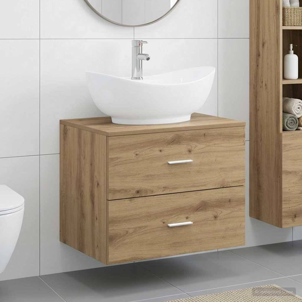 Holzwandmontierte Badezimmerkommode mit zwei Schubladen und einem weißen Aufsatzwaschbecken in einem gefliesten Badezimmer.