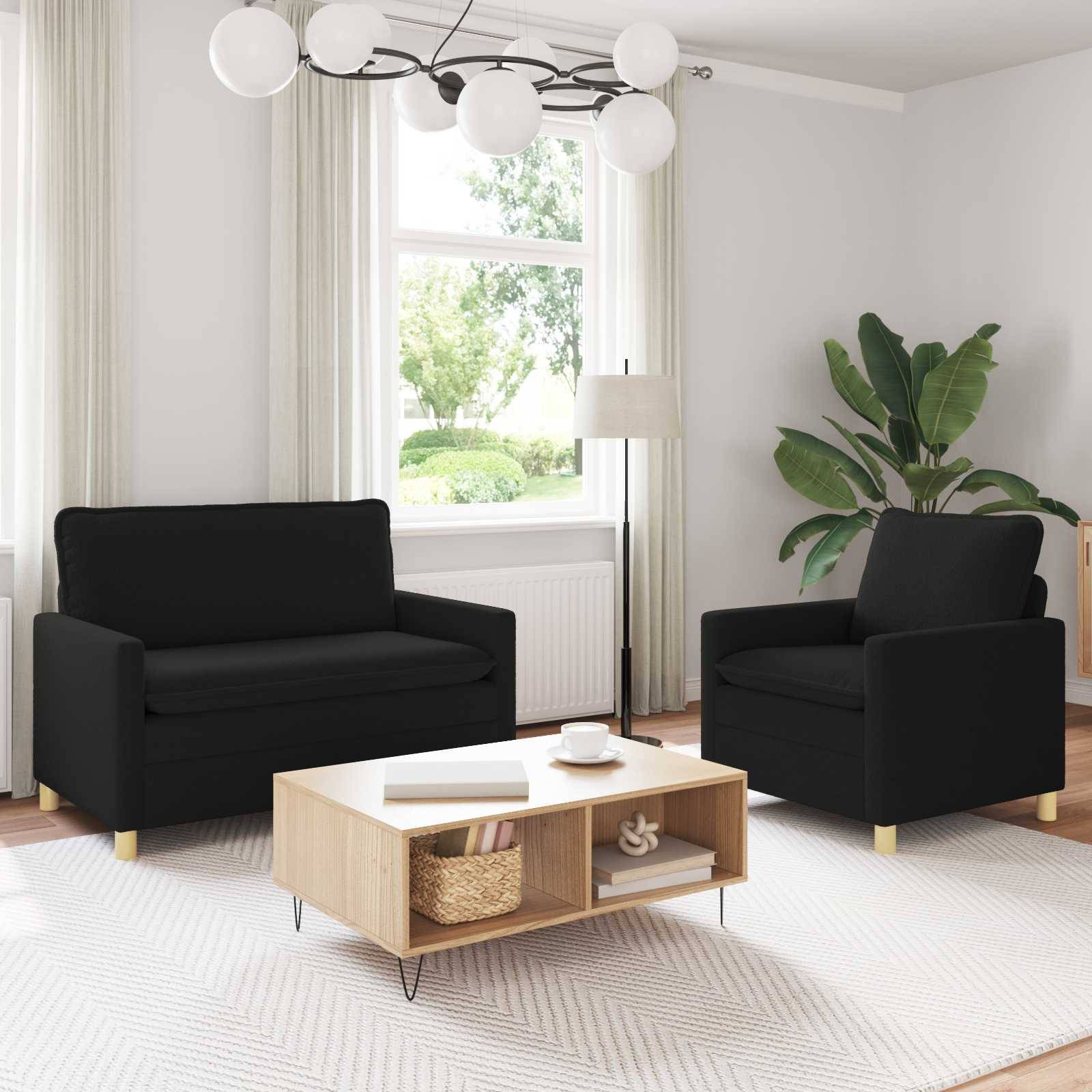 Modernes Wohnzimmer mit zwei schwarzen Sesseln, einem niedrigen Holzkaffeetisch, einer Stehleuchte, einem großen Fenster und einer Topfpflanze auf einem hellen Teppich.
