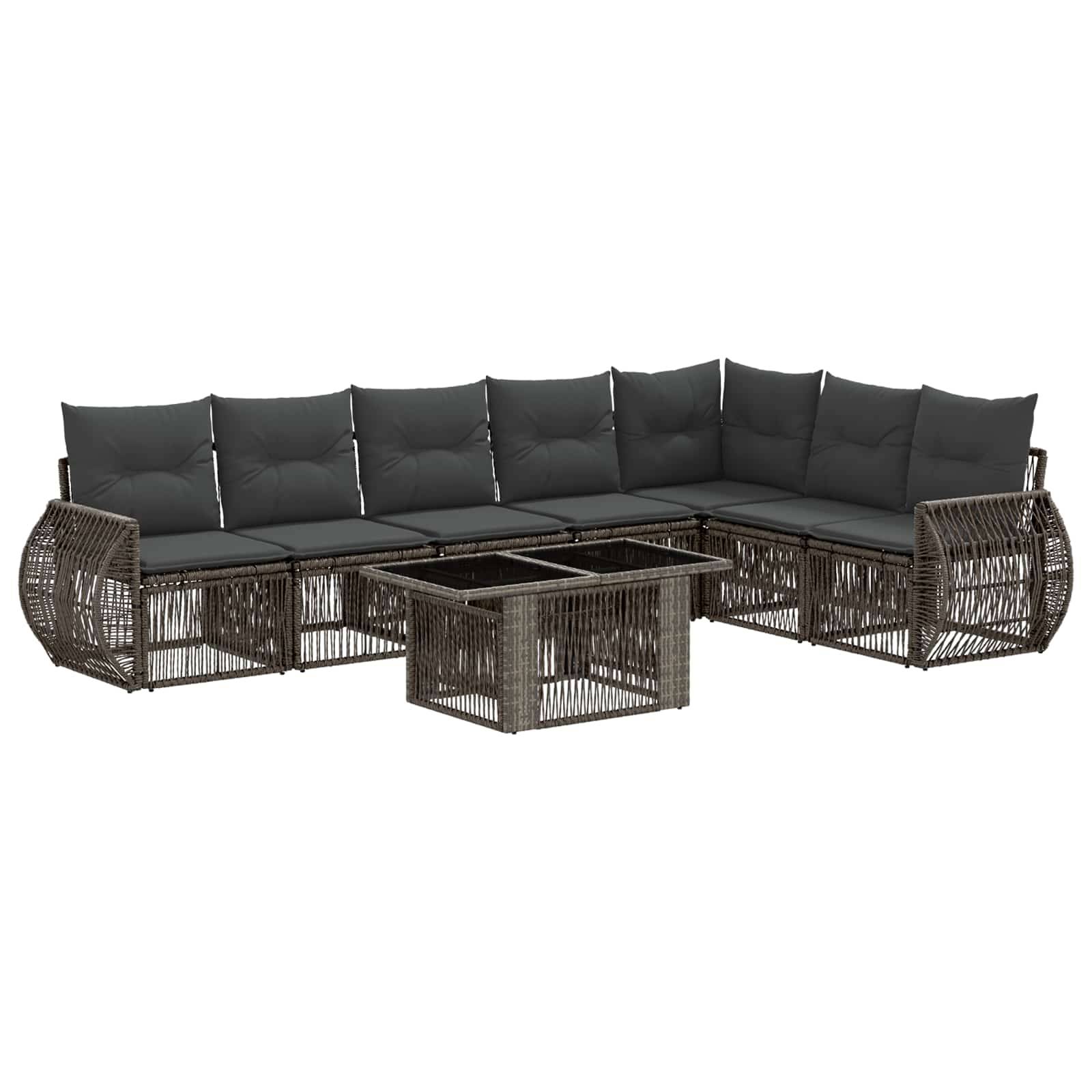 L-förmiges Outdoor-Rattansofa mit dunklen Kissen und passendem Glastisch mit Glasplatte.