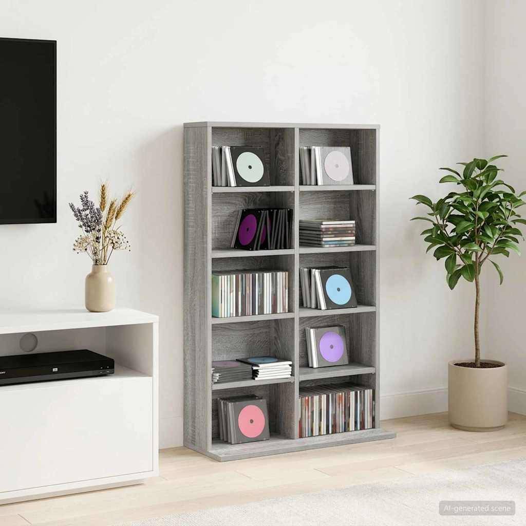 Graues Regal gefüllt mit Schallplatten und CDs in einem minimalistischen Wohnzimmer neben einem Fernseh­ständer und einer Topfpflanze.