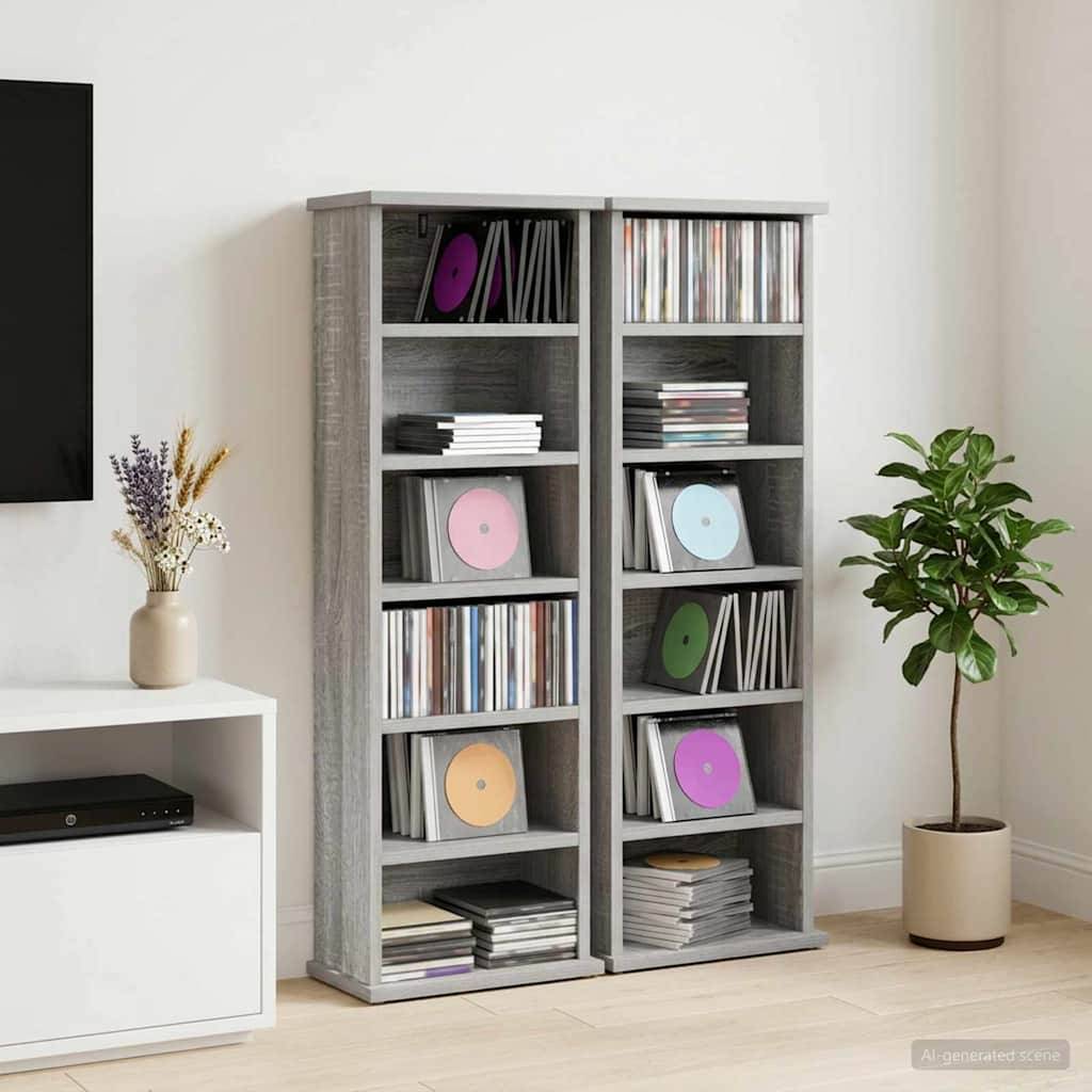 Zwei graue Lagerschränke, gefüllt mit Schallplatten und CDs, stehen in einem Wohnzimmer neben einer Topfpflanze und einer TV-Konsole.