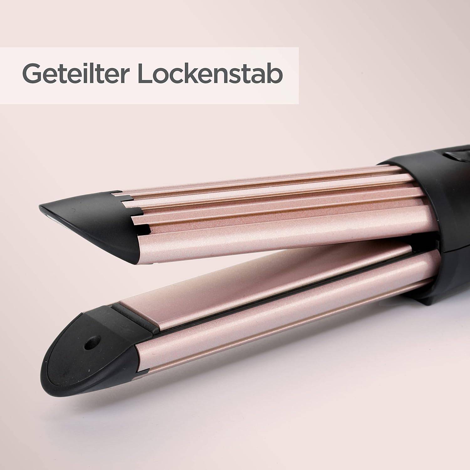 Nahaufnahme eines geteilten Lockenstabs mit zwei rosegoldenen Fässern und schwarzen Spitzen, beschriftet mit „Geteilter Lockenstab