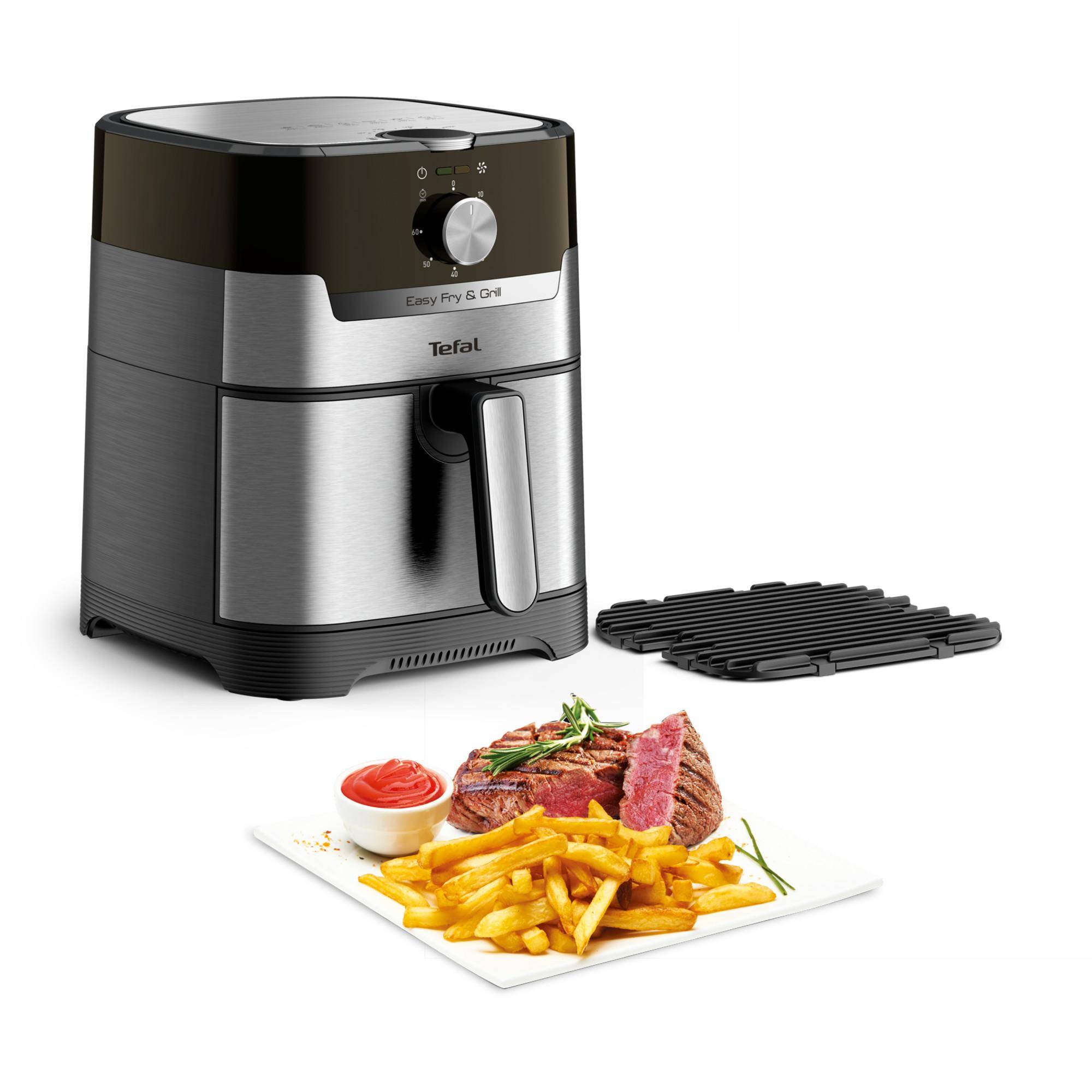 Tefal Easy Fry & Grill Heißluftfritteuse mit Grillrost neben einem Teller mit Steak, Pommes und Sauce