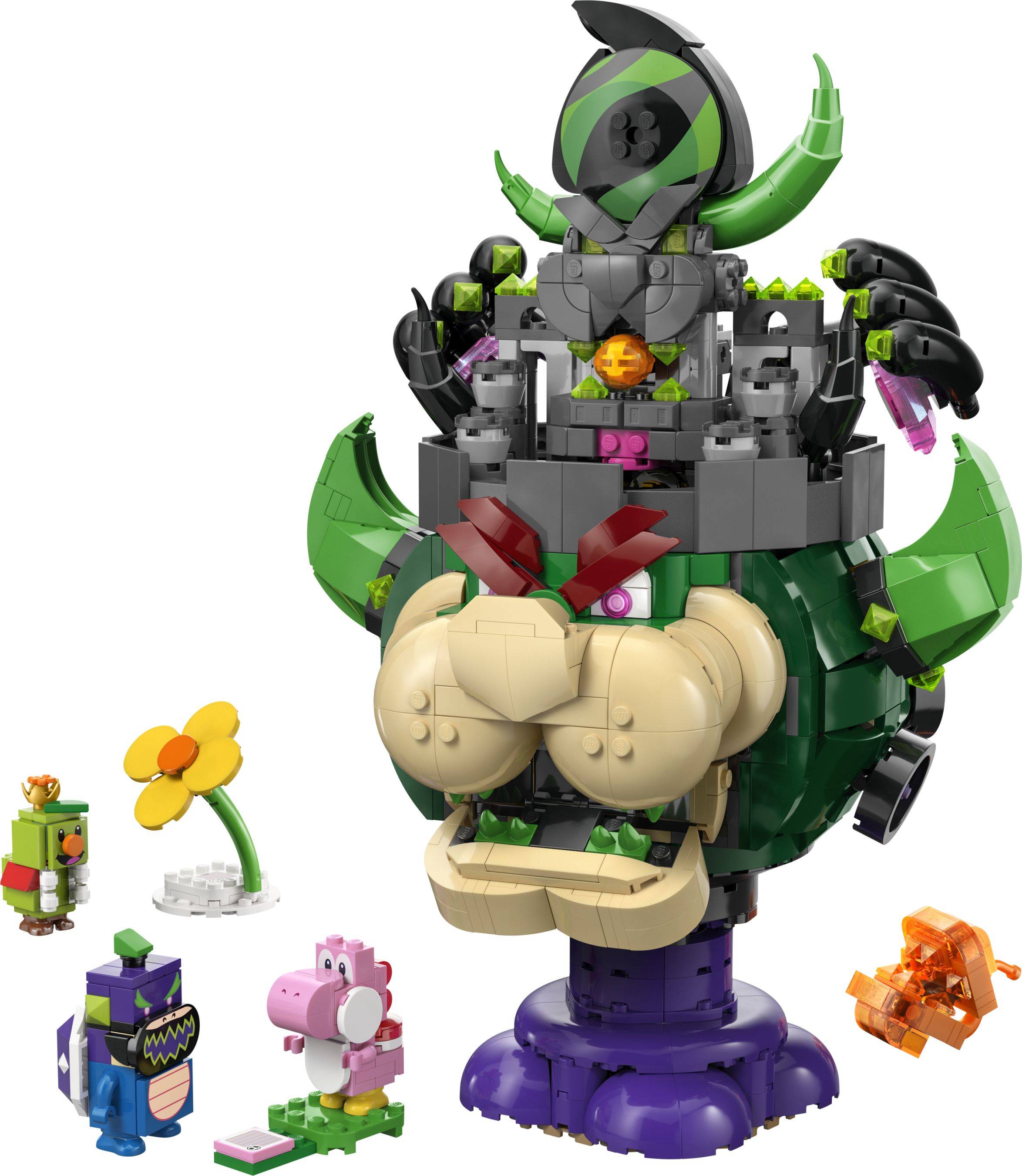 LEGO-ähnliche Monsterfigur mit grünem und violettem Körper, großem beigefarbenem Gesicht und offenem Mund, dargestellt mit vier kleinen Charakterbauten darum herum auf weißem Hintergrund.