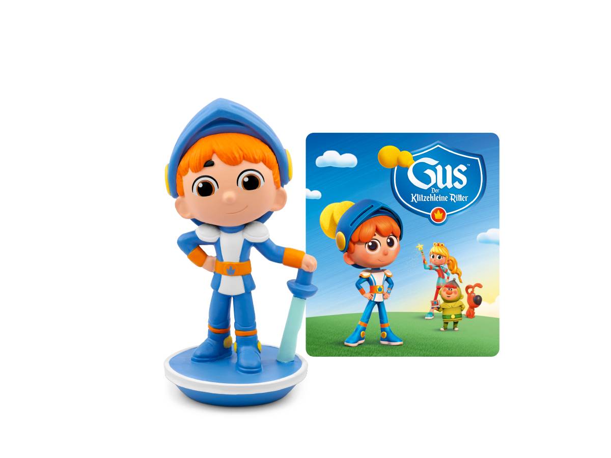 Spielzeugfigur eines blau-orangefarbenen Cartoon-Jungen, der eine Schaufel hält, neben einem Spiel- oder Paketbild der Marke Gus mit derselben Figur und zwei Gefährten.