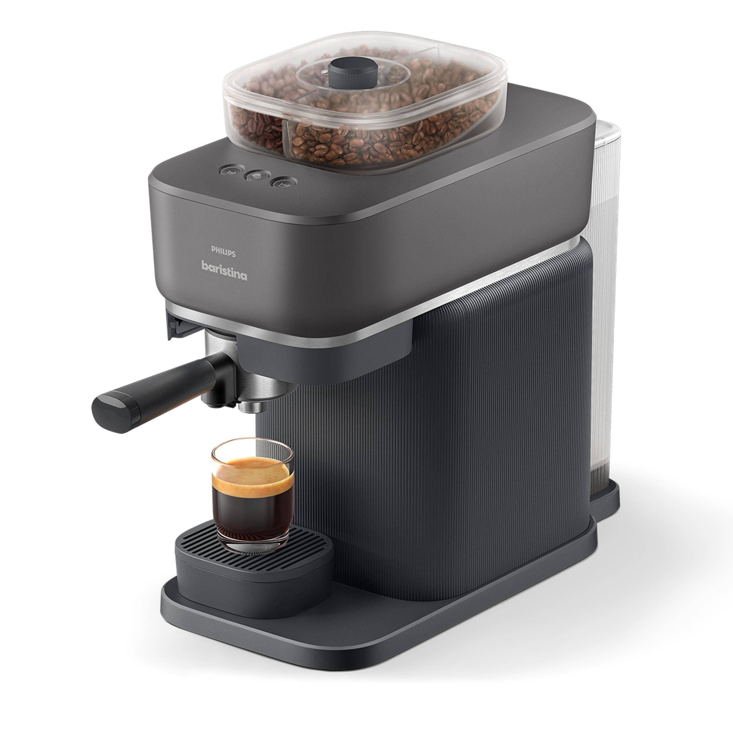 Kompakte schwarze Philips Baristina Espressomaschine mit Bohnenbehälter, die Kaffee in eine kleine Glastasse auf dem Abtropfblech brüht.