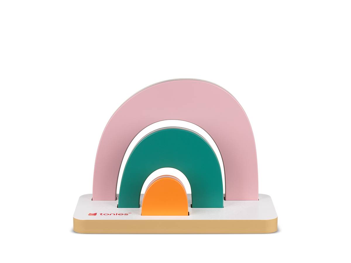 Ein buntes Spielzeug mit geschichteten Bögen in Rosa, Türkis und Orange, die auf einer weißen Basis verschachtelt sind, vor einem schwarzen Hintergrund.