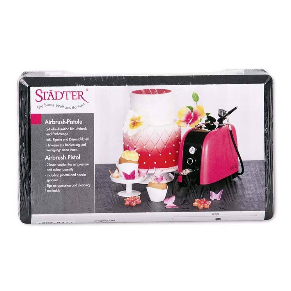 Städter Airbrush-Pistolen-Set-Box mit einer rosa Airbrush-Maschine und einer dekorierten Torte mit Blumenmustern zur Tortendekoration.