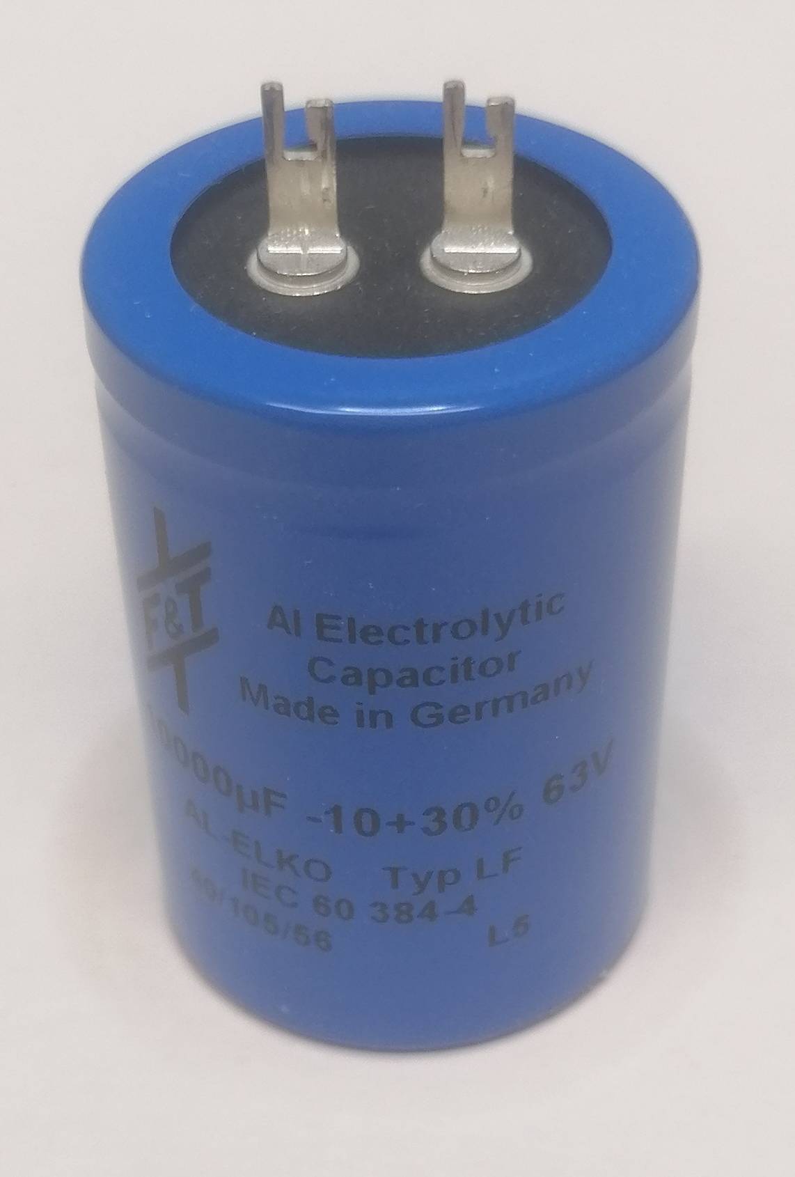 Blauer elektrolytischer Kondensator mit zwei Metallklemmen, gekennzeichnet als 