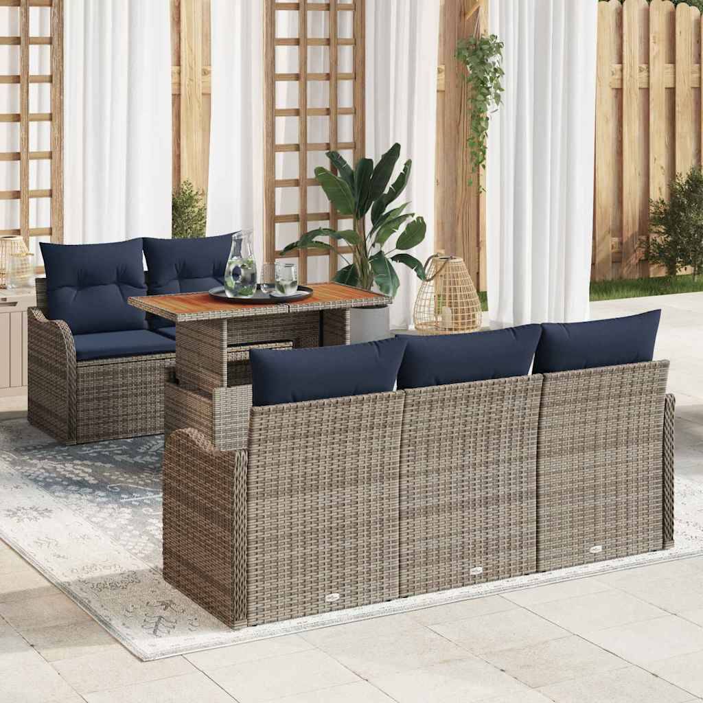 Outdoor-Terrassenmöbelset mit Rattansofas, marineblauen Kissen und einem Glastisch mit Glasplatte auf einem gemusterten Teppich.