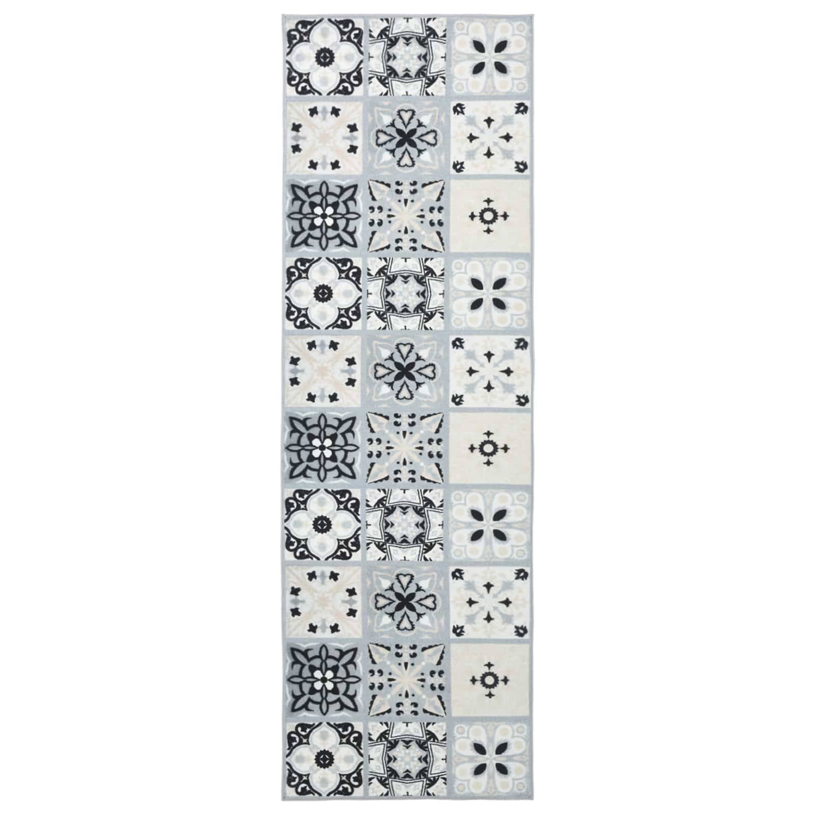 Ein vertikaler Streifen gemusterter Fliesen in Schwarz, Grau und Weiß, der wiederholte florale und geometrische Motive zeigt, die in einem Mosaik angeordnet sind.