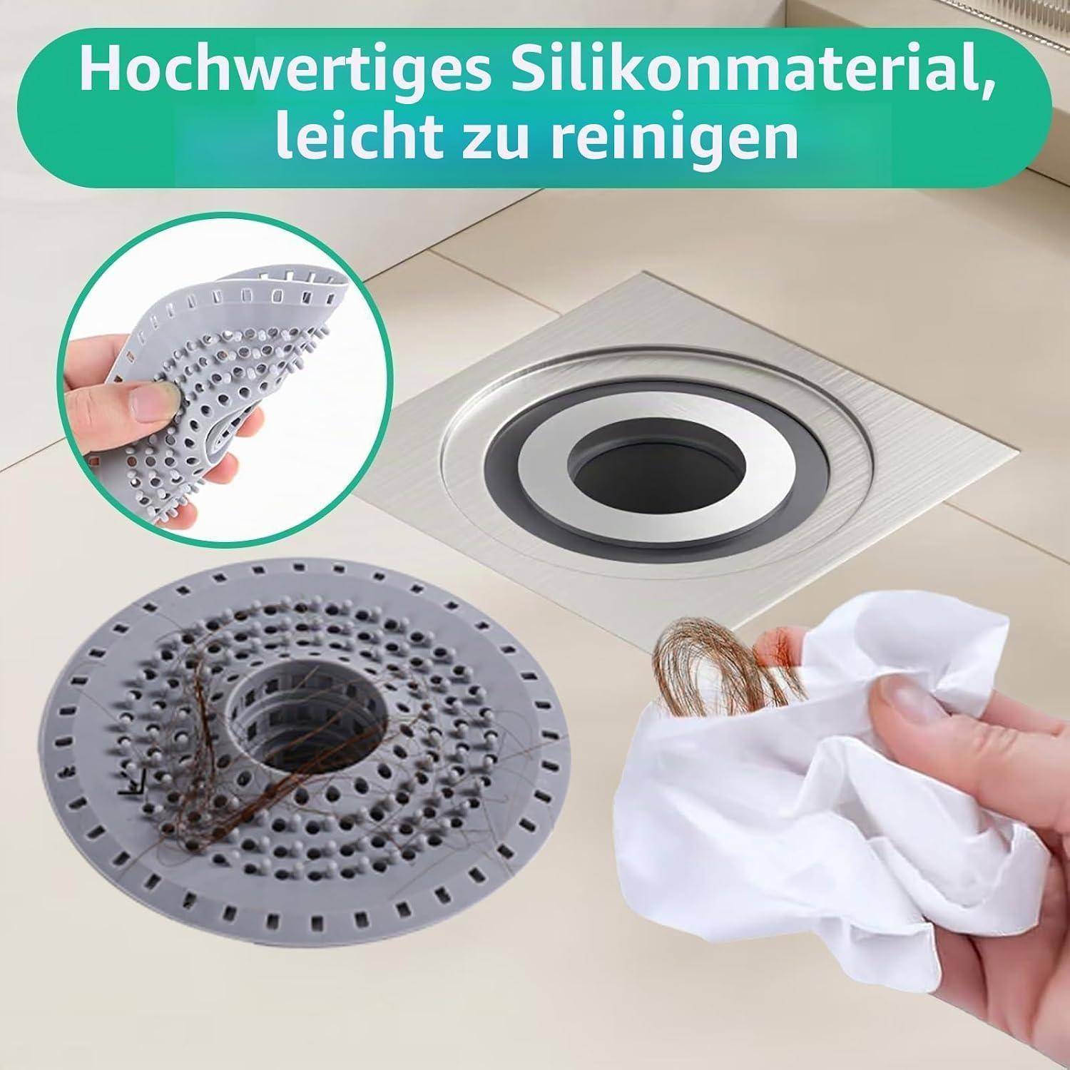 Werbebild einer grauen Silikon-Ablaufabdeckung in einem Bodenablauf, die gebogen und abgewischt wird; deutscher Text sagt „Hochwertiges Silikonmaterial, leicht zu reinigen