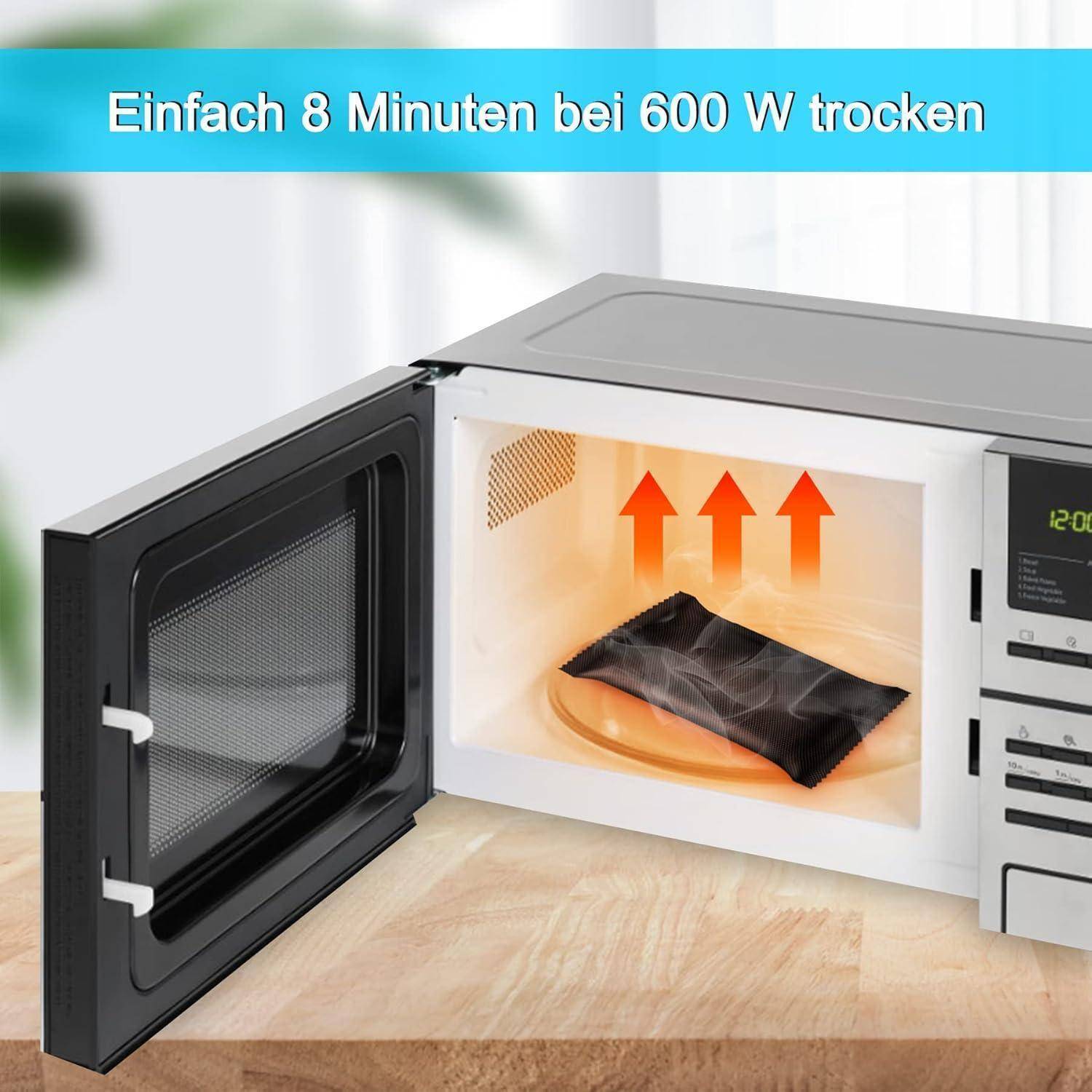 Mikrowelle geöffnet mit einem schwarzen Lebensmittelbeutel darin; der deutsche Text sagt „Einfach in 8 Minuten bei 600 W trocknen