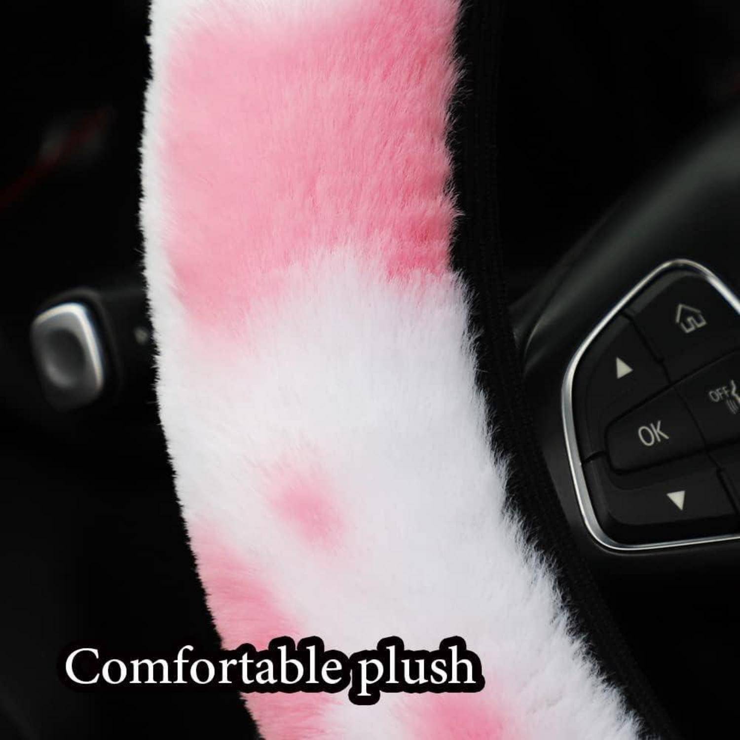 Rosa-weiße Plüsch-Lenkradabdeckung auf einem Autolenkrad, mit dem Text "Komfortables Plüsch"" unten überlagert.