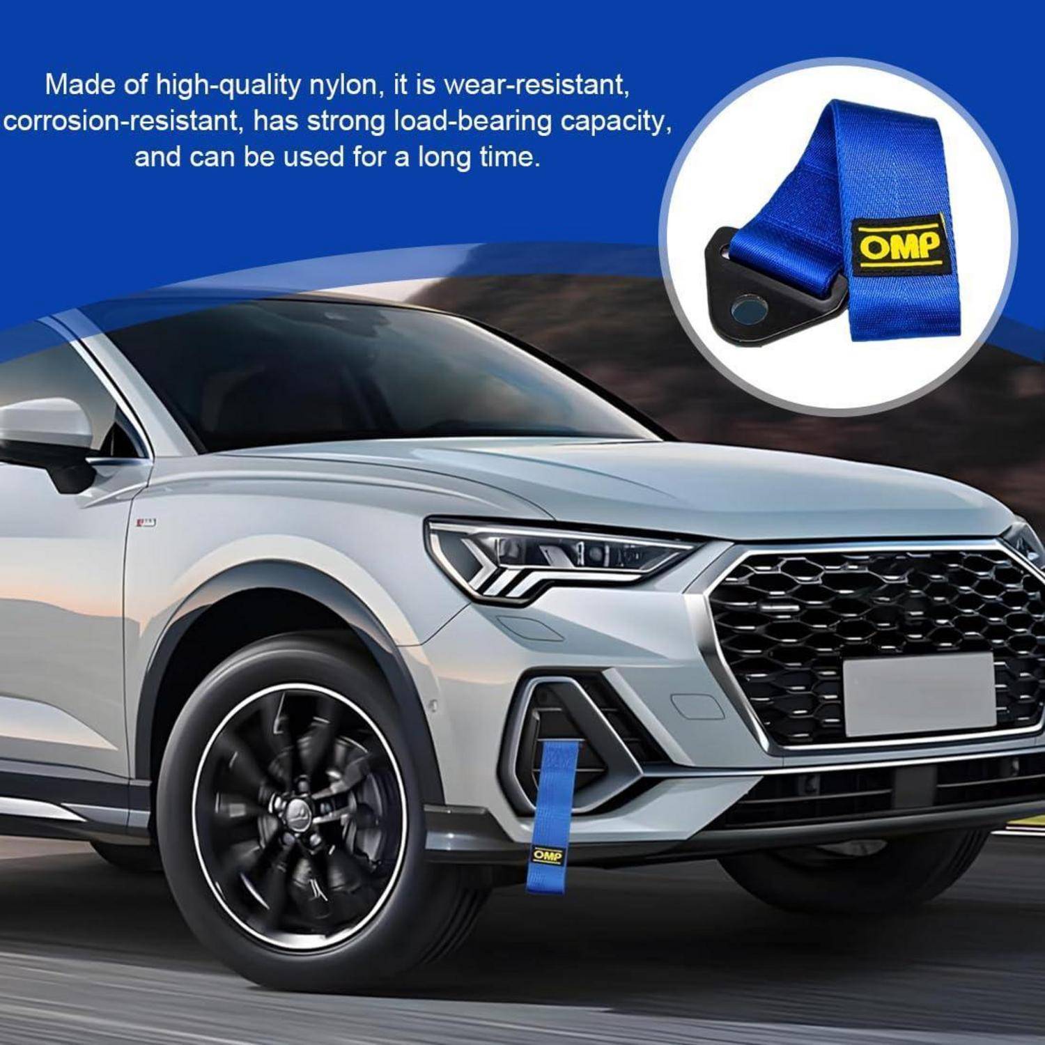 Silberner SUV mit einem blauen Abschleppgurt, der an der vorderen Stoßstange befestigt ist; die Vergrößerung zeigt den blauen Nylon-Gurt mit OMP-Logo und Text über Verschleißfestigkeit und Tragfähigkeit.