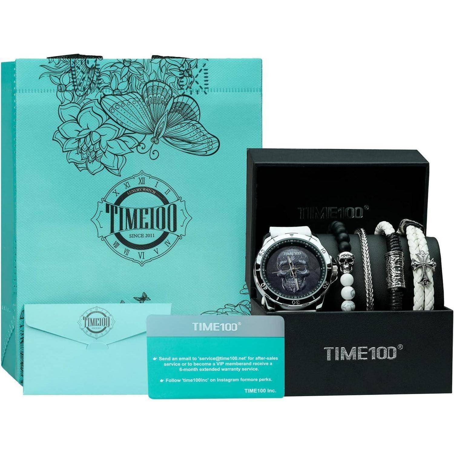 TIME100 Uhr-Geschenkset mit einer Armbanduhr und mehreren Armbändern in einer schwarzen Präsentationsbox, gezeigt mit türkisfarbenem Markenbrand-Verpackungsmaterial und Karte.