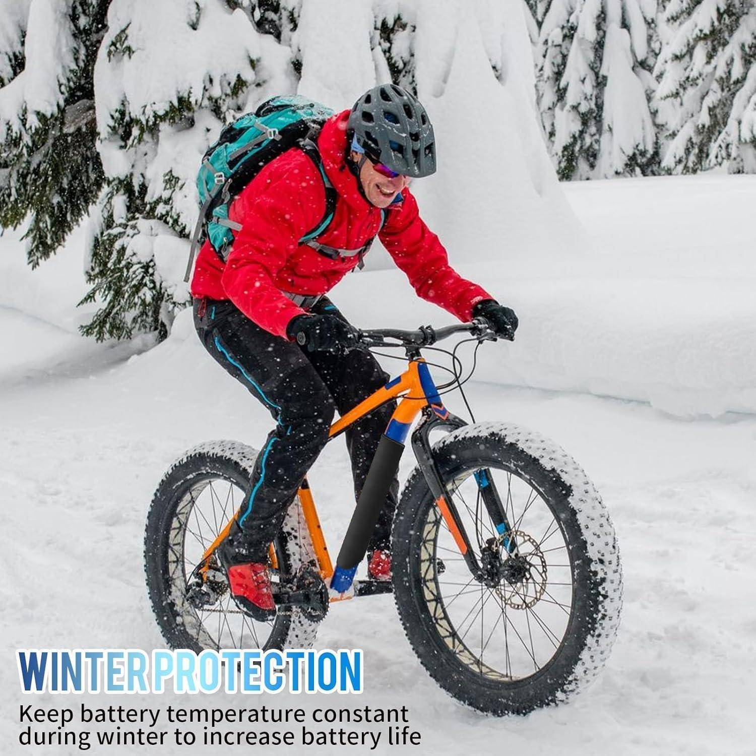 Mountainbiker in roter Jacke fährt ein Fatbike durch tiefen Schnee, mit Text der lautet „WINTERSCHUTZ" und „Halten Sie die Batterietemperatur im Winter konstant, um die Batterielebensdauer zu verlängern"".