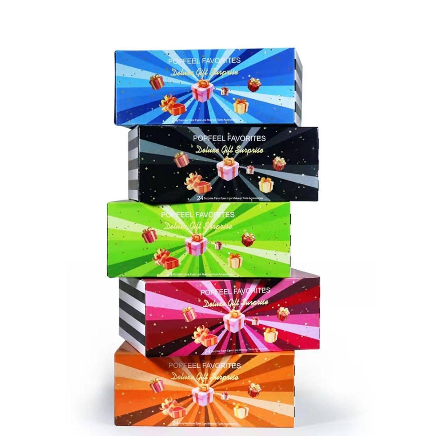 Stapel von fünf Popfeel Favorites Deluxe-Geschenkboxen in verschiedenen Farben, jede mit einer Geschenkbox-Grafik auf einem Strahlenhintergrund verziert.