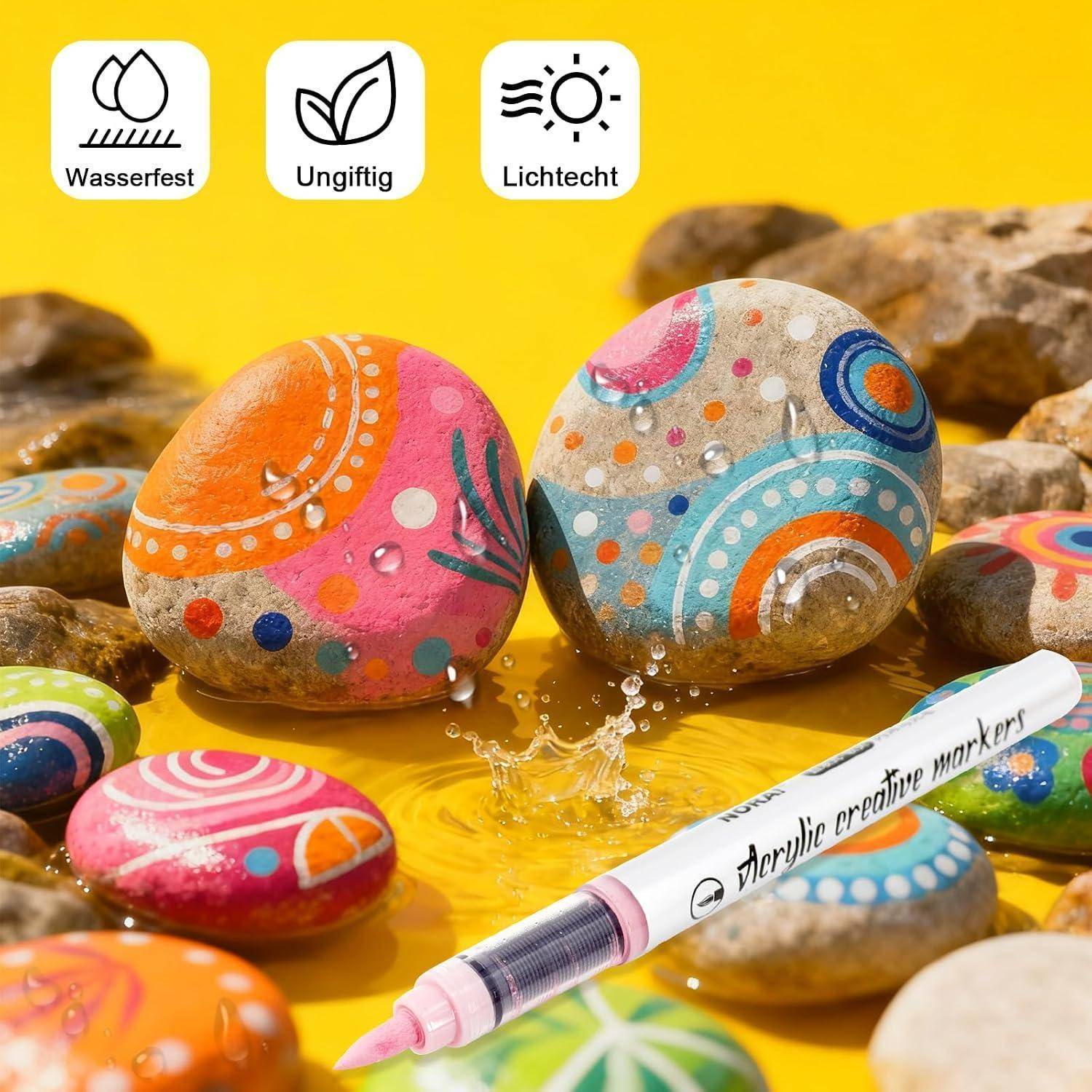 Mit einem Marker farbenfroh bemalte Steine, dargestellt als wasserfest, ungiftig und lichtechtfarben.