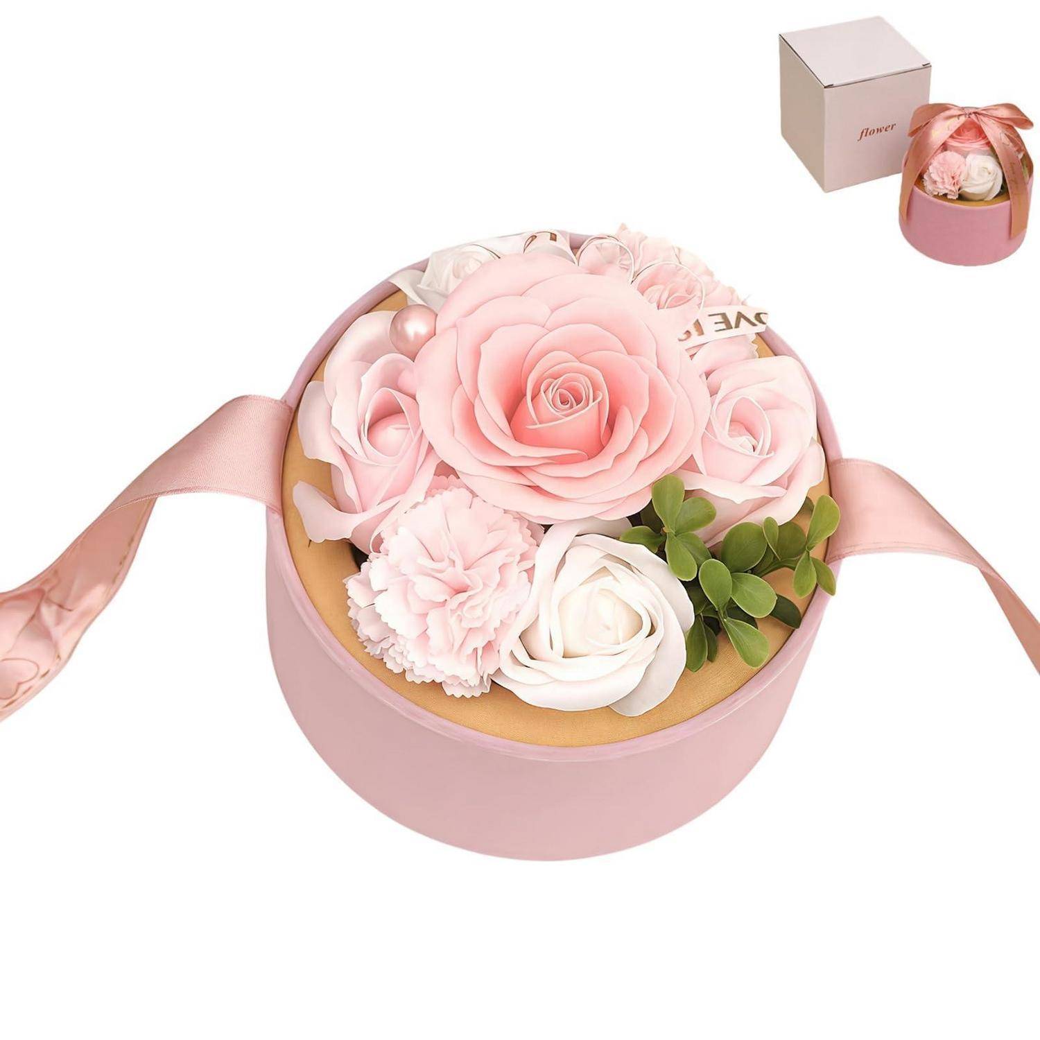Rosa runde Geschenkbox mit Schleife, gefüllt mit künstlichen rosa und weißen Blumen und Grünpflanzen; kleine Produktbox in der Ecke dargestellt.