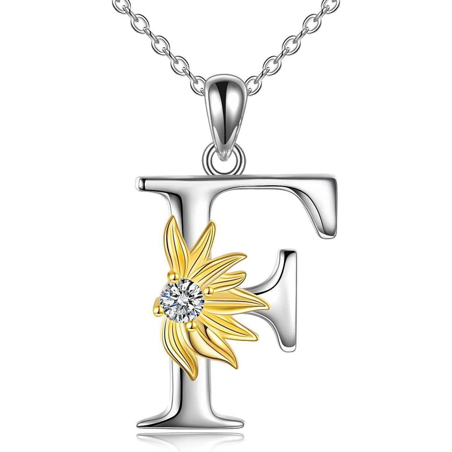 Silberner Buchstabe-F-Anhänger-Halskette mit goldener Blume und klarem Edelstein-Akzent, gezeigt vor weißem Hintergrund.