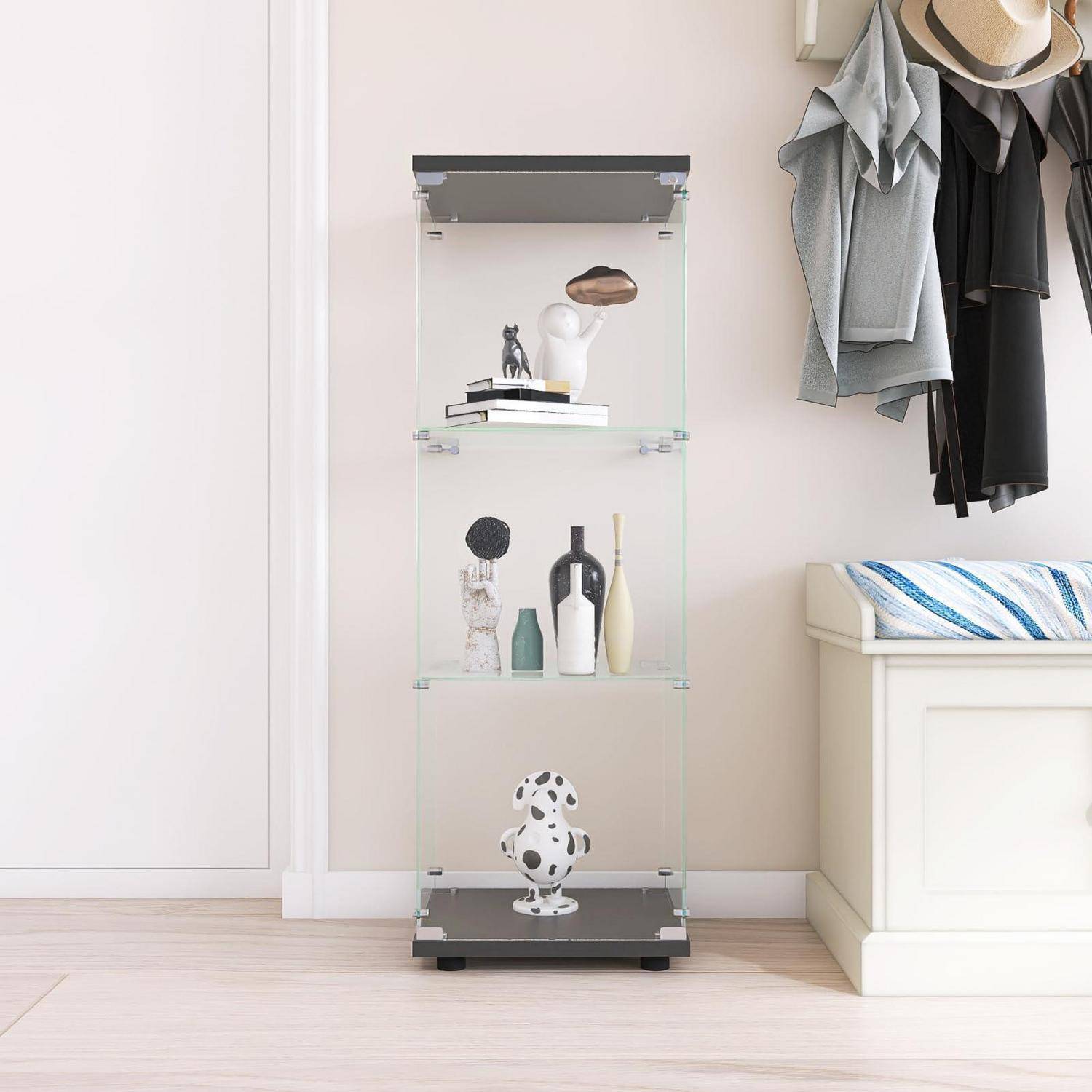 Kleine Glasvitrine mit Regalen, die Dekorationsgegenstände hält, neben hängenden Mänteln und einer Bank in einem hellen Raum.