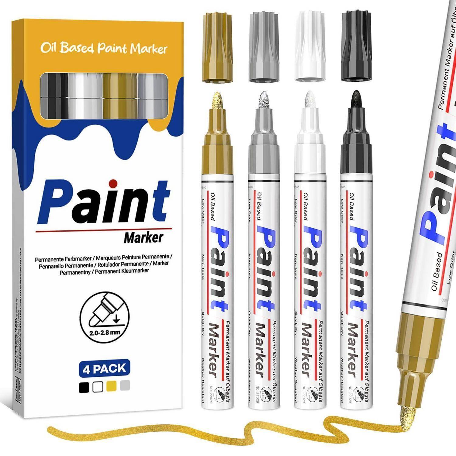 Verpackung und vier ölbasierte Kunstmalerstifte mit Gold-, Silber-, Weiß- und Schwarzspitzen, plus eine goldene Linie, die mit einem Stift gezogen wurde; die Schachtel sagt „Paint Marker