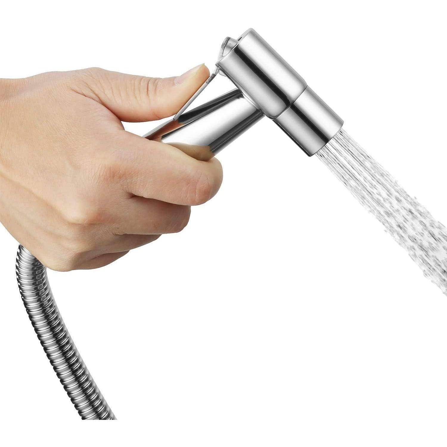 Hand hält eine Chrom-Bidet-Sprühdüse, die einen Wasserstrom gegen einen weißen Hintergrund sprüht.