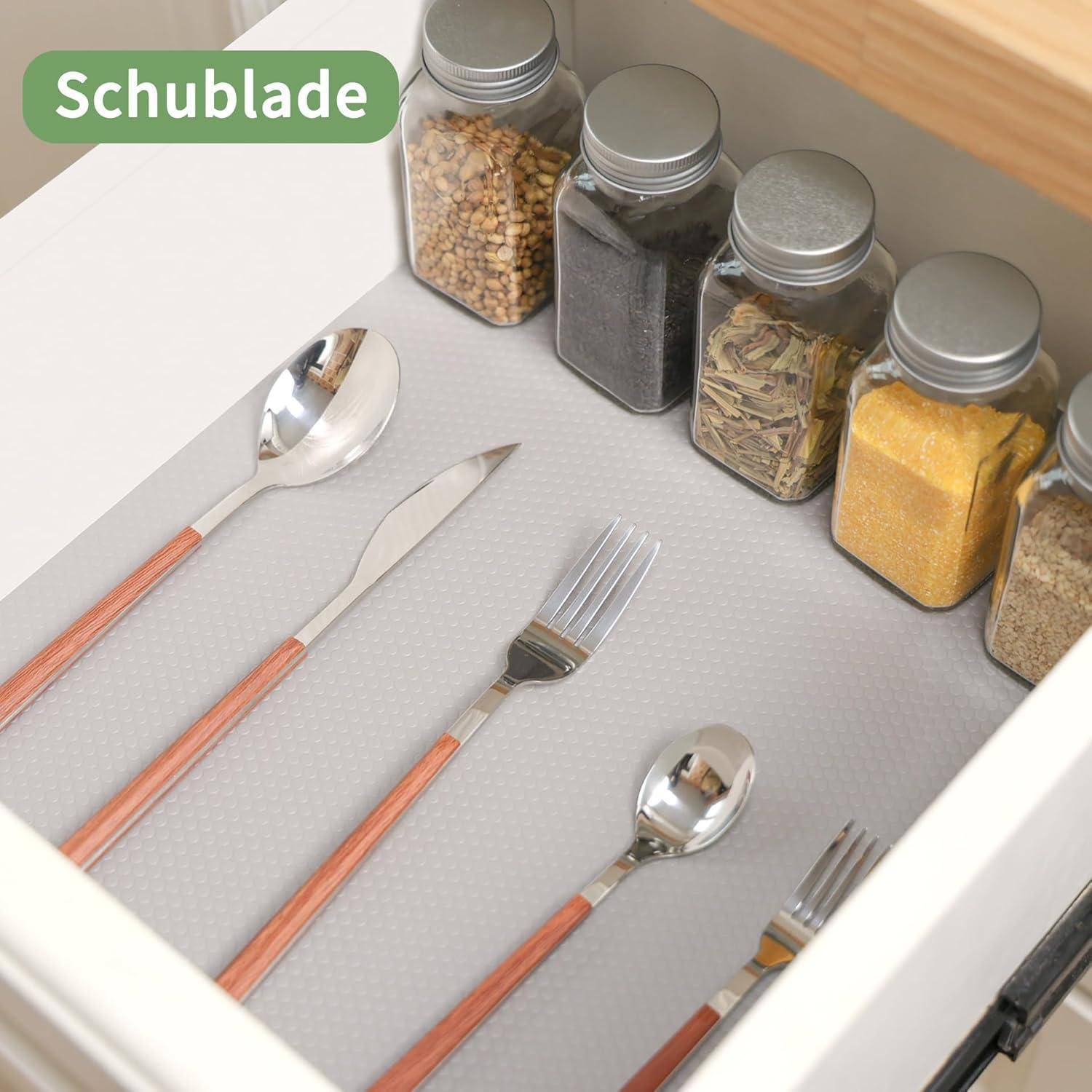 Küchenschublade mit kupfergestieltem Besteck und Gewürzgläsern entlang der Rückseite, beschriftet mit „Schublade