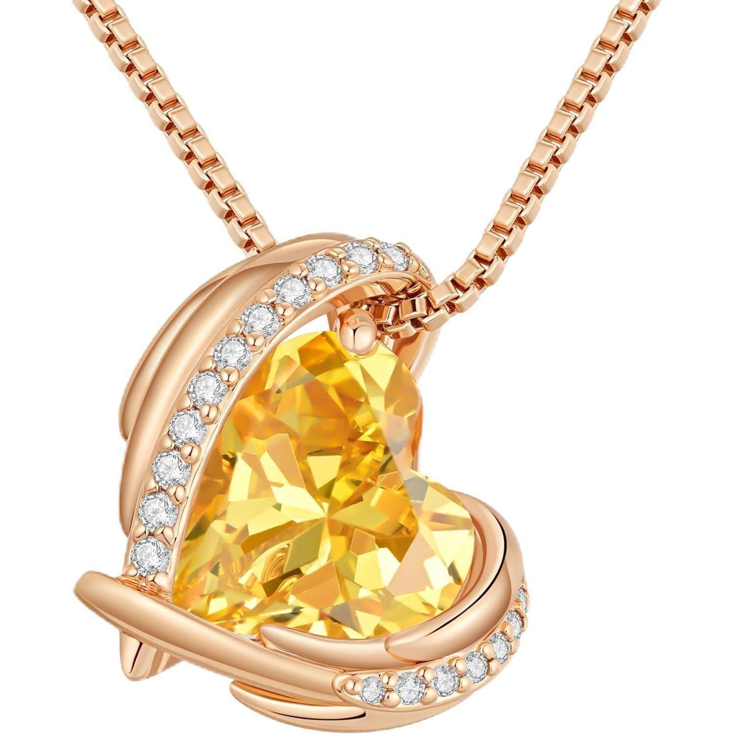 Roségold-Herz-Anhänger-Halskette mit facettiertem gelbem Edelstein in der Mitte und kleinen klaren Steinen entlang der geschwungenen Fassung.