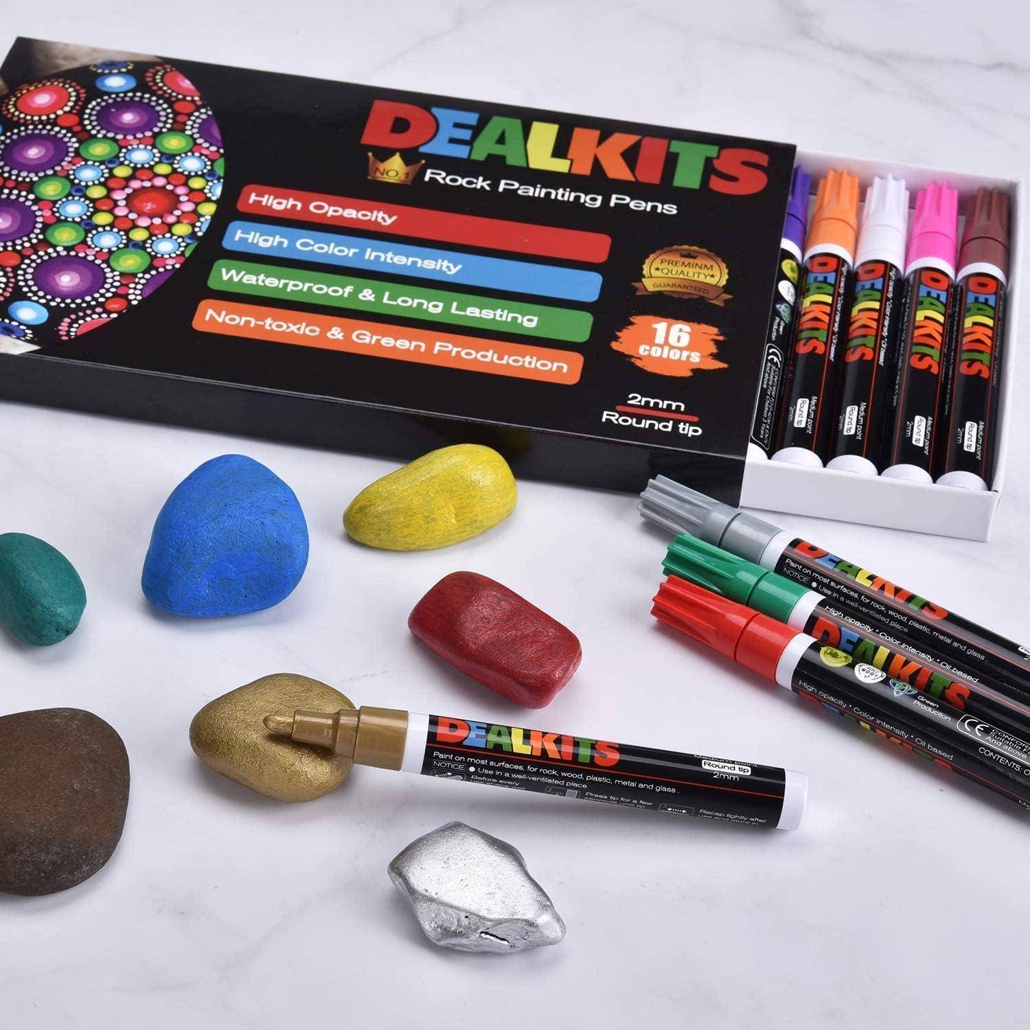 DEALKITS Steine-Malstift-Set mit 16 Farben und 2 mm runden Spitzen, dargestellt mit bemalten Steinen und mehreren Stiften auf weißer Oberfläche.
