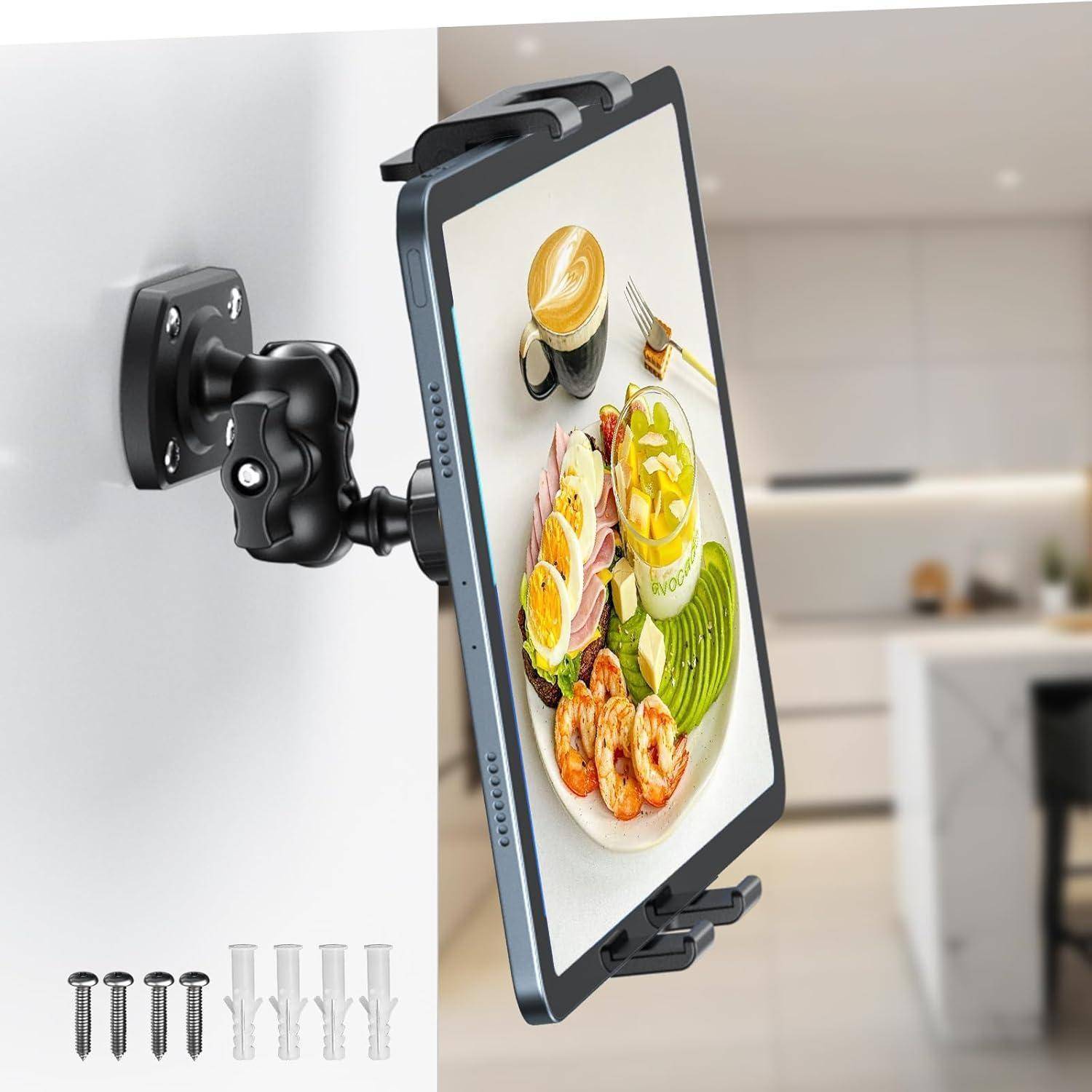 Tablet an einem verstellbaren Wandarm in einer Küche montiert, zeigt ein Lebensmittelbild auf dem Bildschirm und enthält darunter Schrauben und Dübel zur Installation.