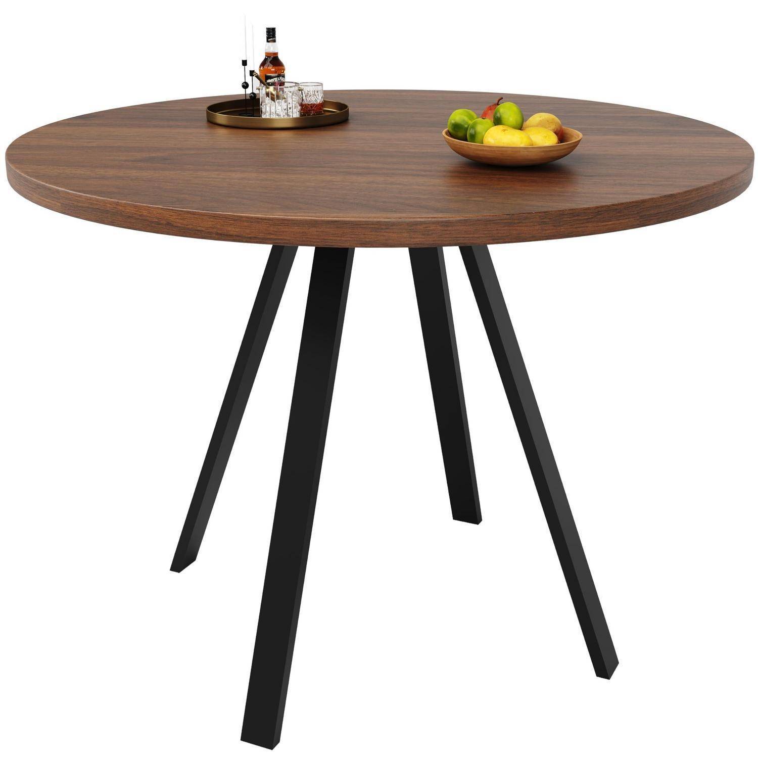 Runder Holzesstisch mit schwarzen schrägen Beinen, gezeigt mit einem Tablett mit Gläsern und einer Flasche sowie einer Obstschale.