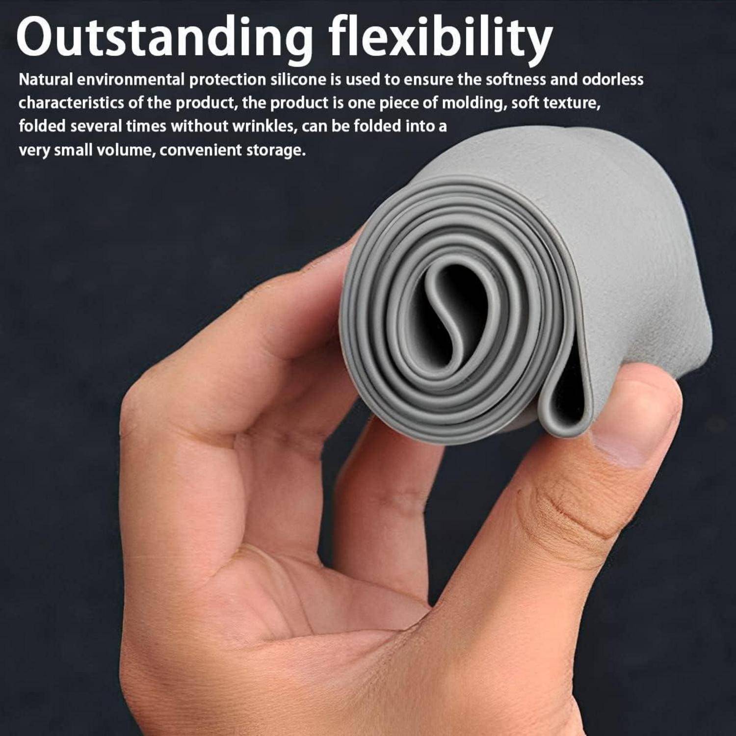 Hand hält eine aufgerollte graue Silikonmatte und zeigt ihr flexibles, faltbares Design; Text sagt „Hervorragende Flexibilität" und weist auf kompakte Lagerung hin.