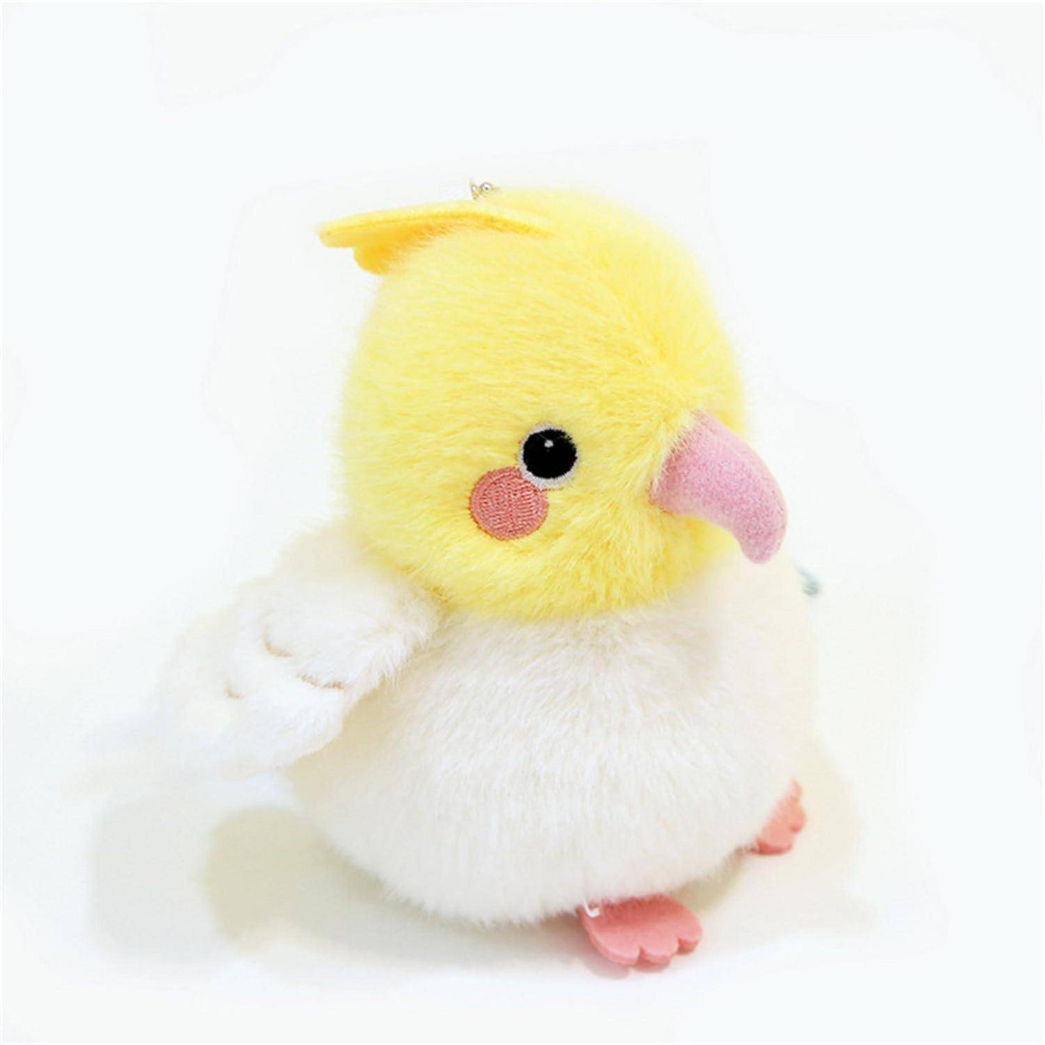 Ein kleines, flauschiges gelb-weißes Vogel-Spielzeug mit rosa Schnabel und Füßen, gezeigt auf weißem Hintergrund.