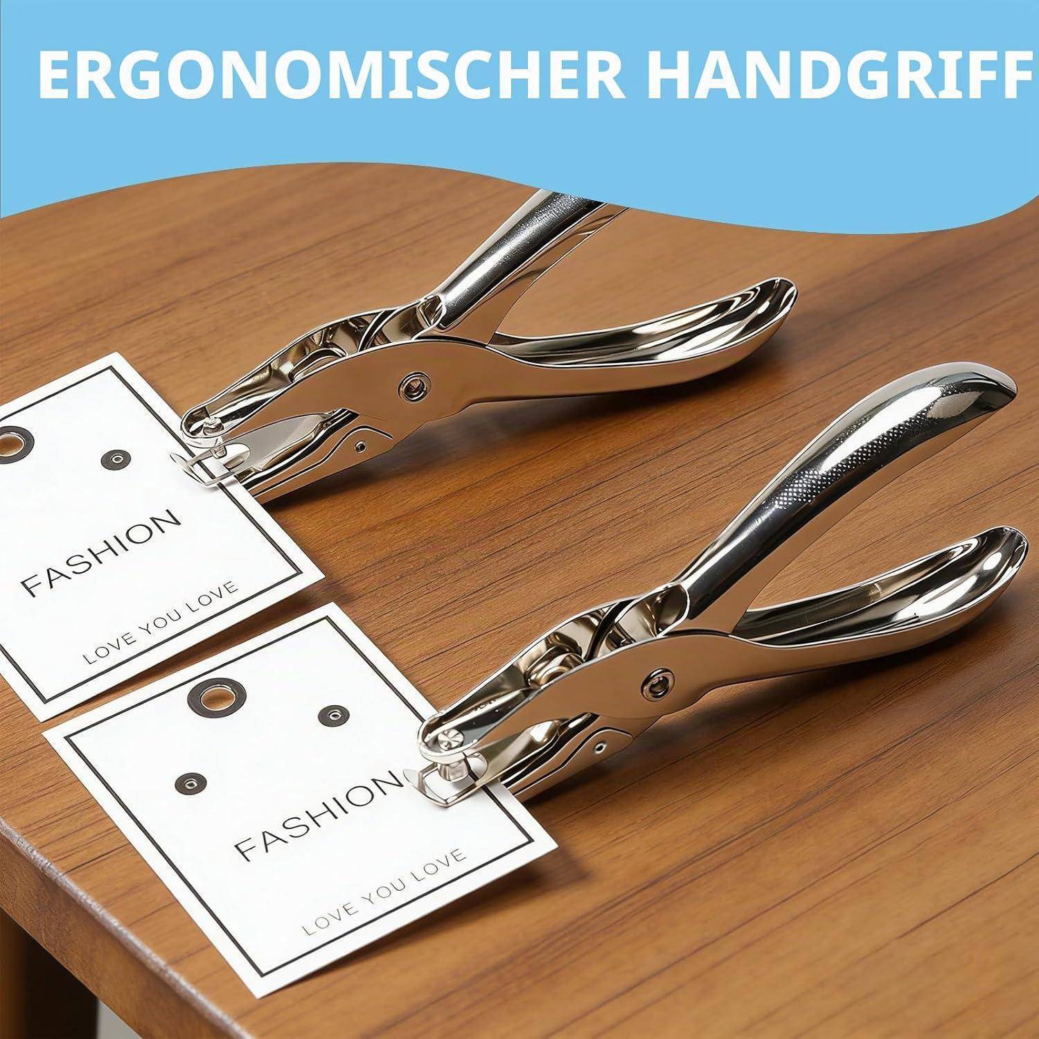 Zwei chromfarbene ergonomische Handlochzangen auf einem Holztisch stanzen Lochmarkierungen mit den Beschriftungen „FASHION