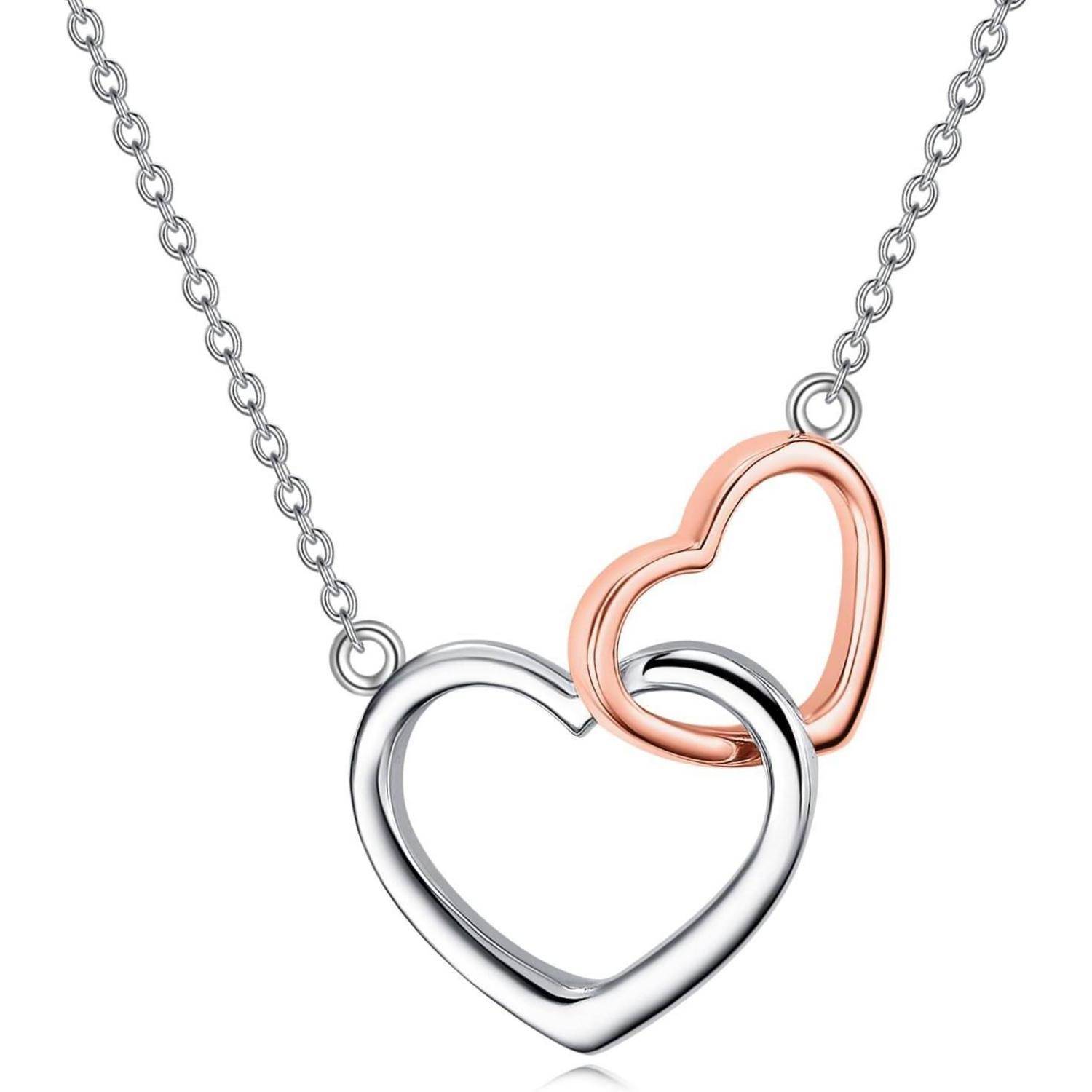 Zwei ineinander verschlungene herzförmige Anhänger, einer in Silber und einer in Roségold, hängend an einer silbernen Kette.