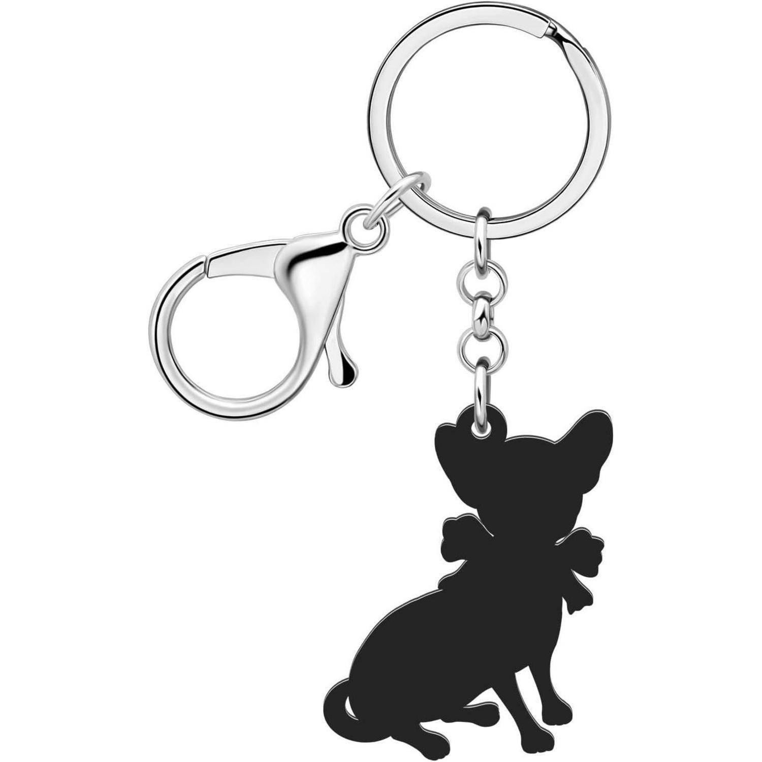 Metallschlüsselanhänger mit kreisförmigem Ring und Verschluss, an dem ein schwarzes Silhouetten-Charm eines sitzenden Hundes mit einer Schleife befestigt ist.