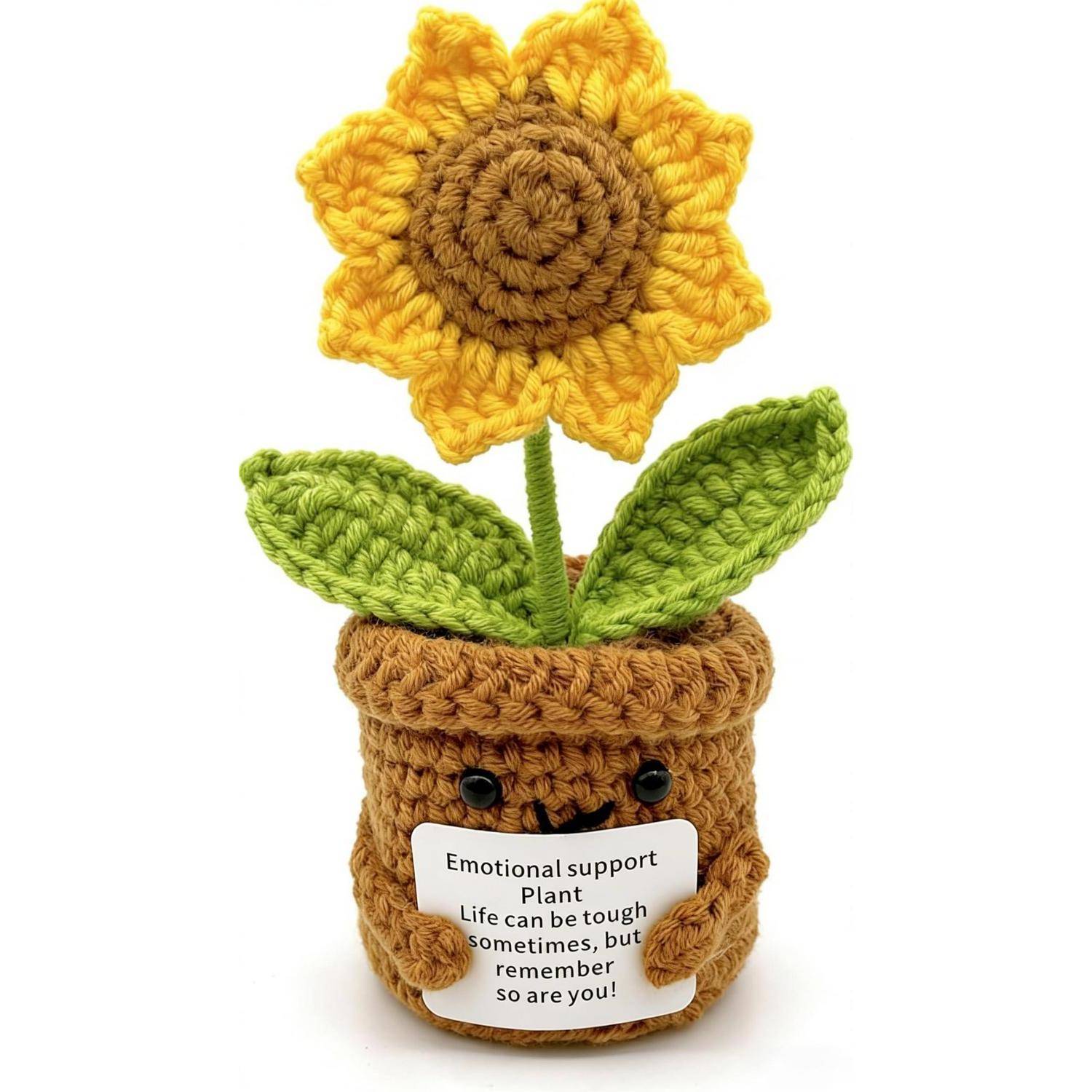 Gehäkelte Topfsonnenblume mit einem lächelnden Blumentopf, der ein Schild hält, das lautet: „Emotionale Unterstützungspflanze Das Leben kann manchmal schwierig sein, aber denk daran, du auch!