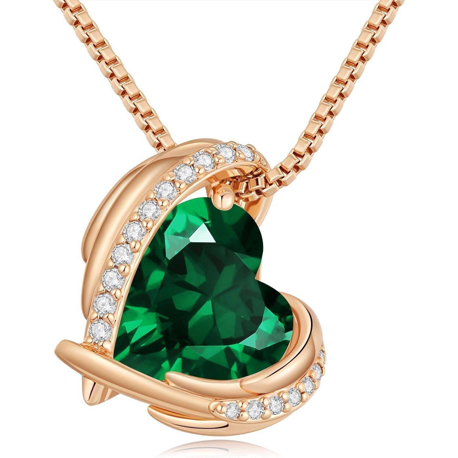 Rosegold-Herz-Anhänger-Halskette mit einem großen grünen Edelstein und kleinen klaren Steinen entlang der geschwungenen Fassung.