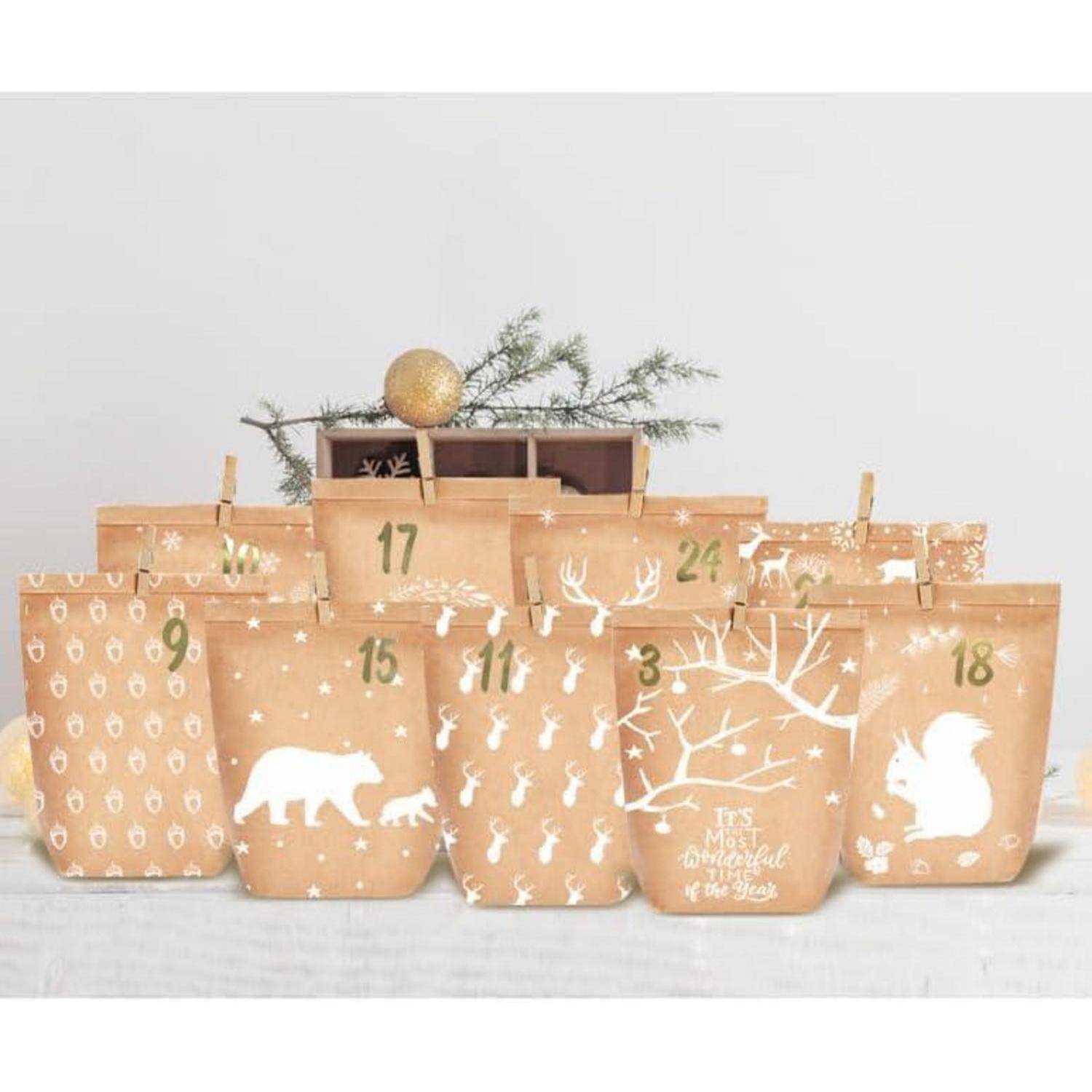 Reihe von braunen Papierweihnachtsgeschenktüten, die wie ein Adventskalender angeordnet sind, mit den Nummern 3 bis 24 nummeriert und mit weißen Wintermotiven verziert.