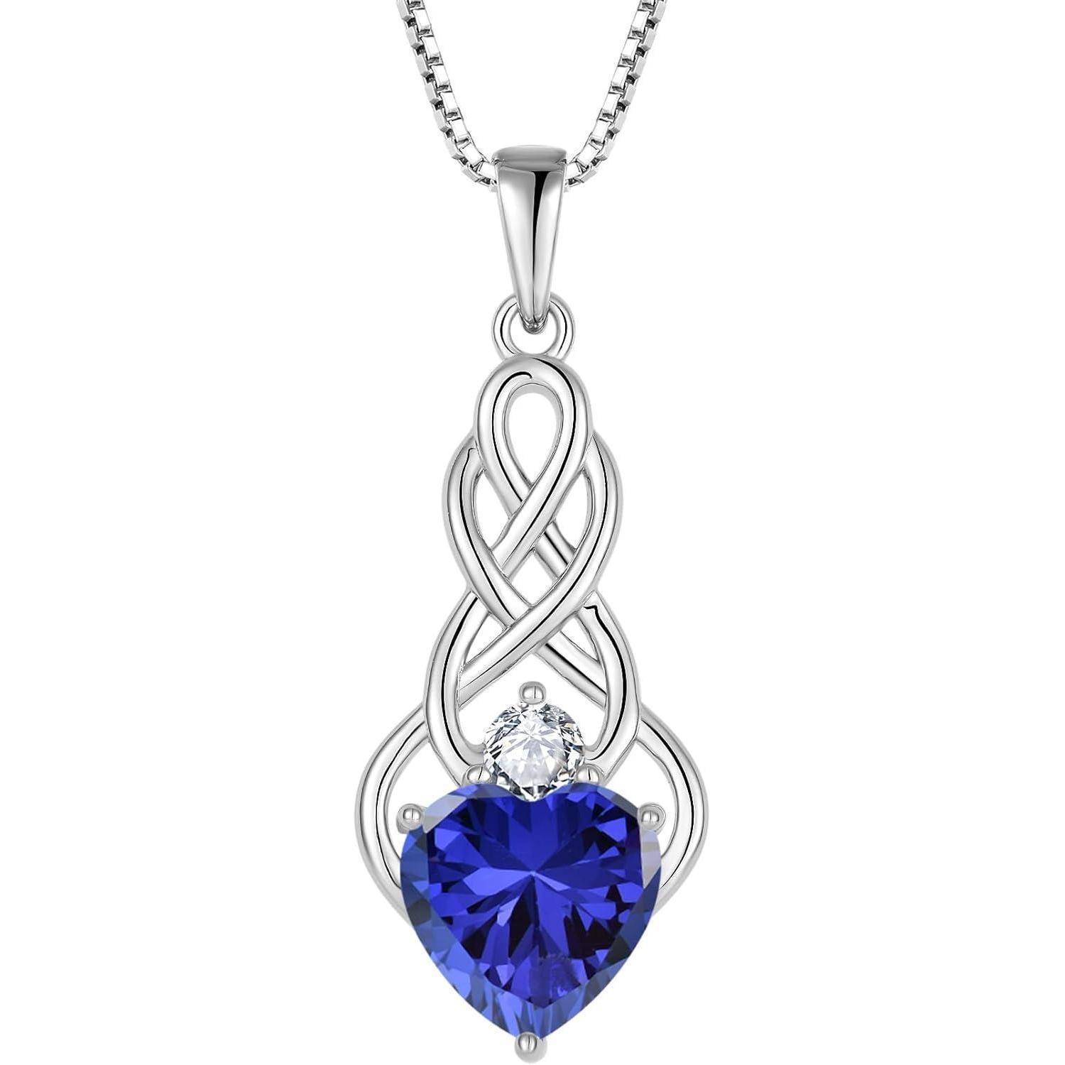 Silberanhänger-Halskette mit einem kunstvollen Schleifendesign und einem blauherz-förmigen Edelstein, gekrönt von einem kleinen klaren Stein.