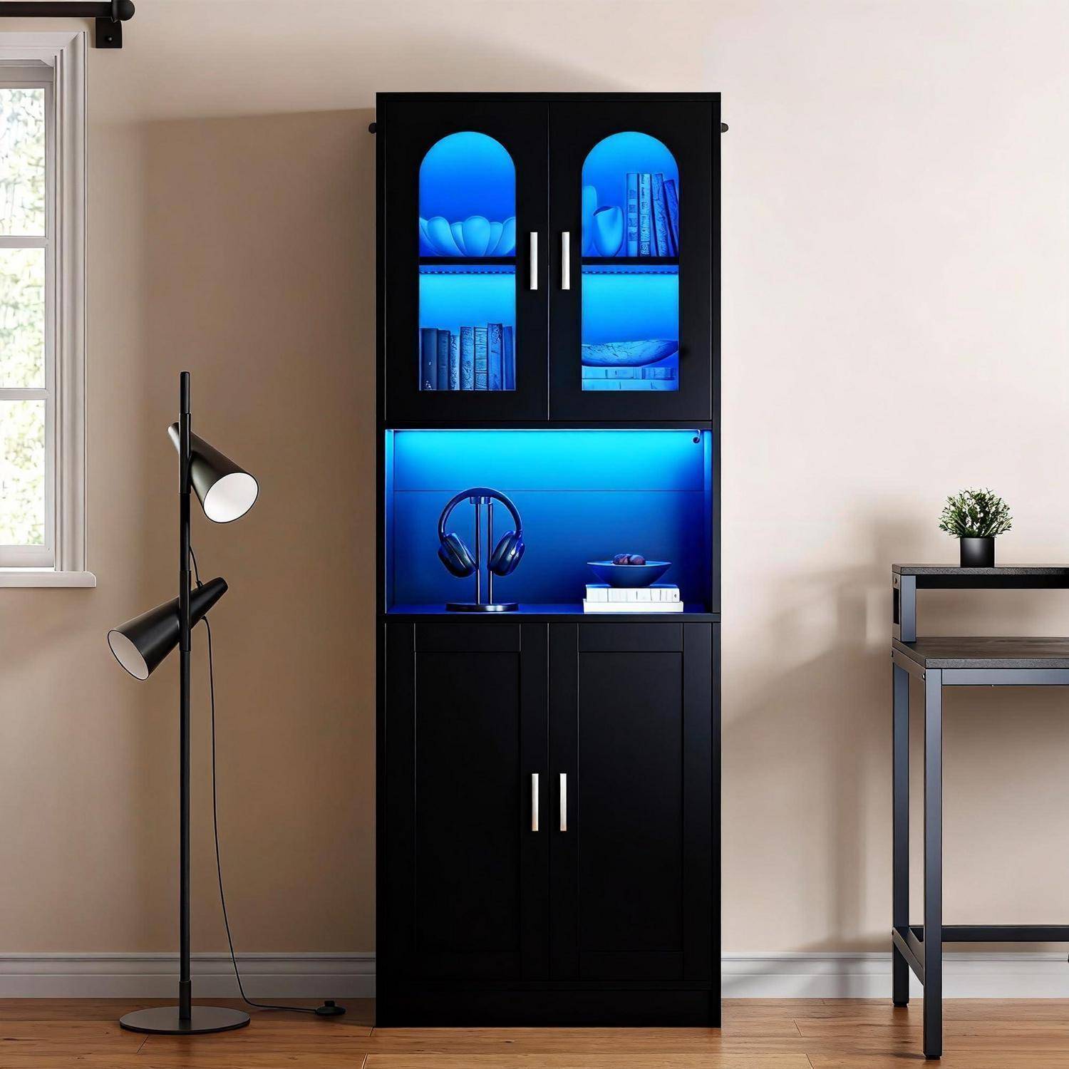 Schwarzer Vitrinenschrank mit blau beleuchteten Regalen, auf denen Bücher und Kopfhörer stehen, steht gegen eine beige Wand in einem modernen Zimmer.