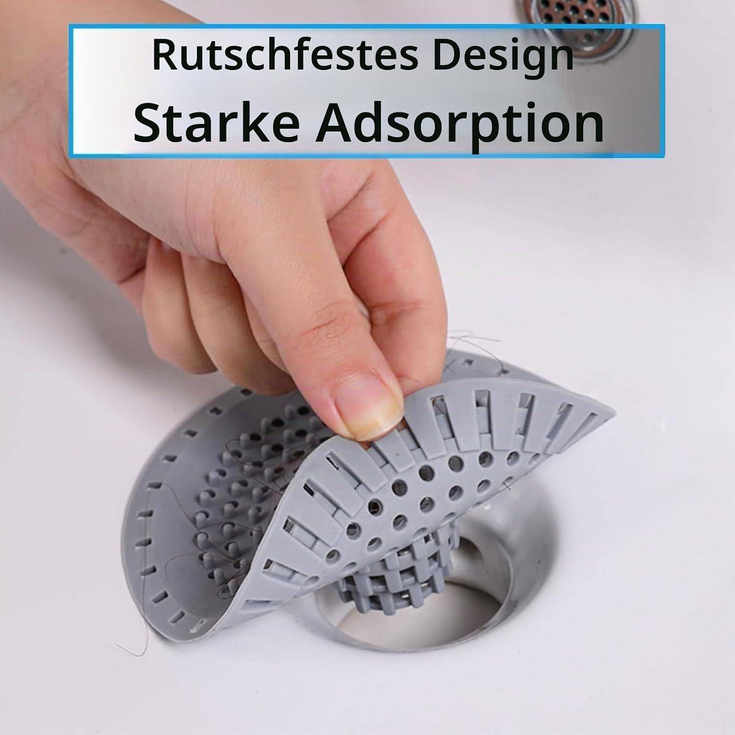 Hand hebt einen grauen rutschfesten Spülbeckensieb mit gelochten Seiten; Deutscher Text liest sich als „Rutschfestes Design