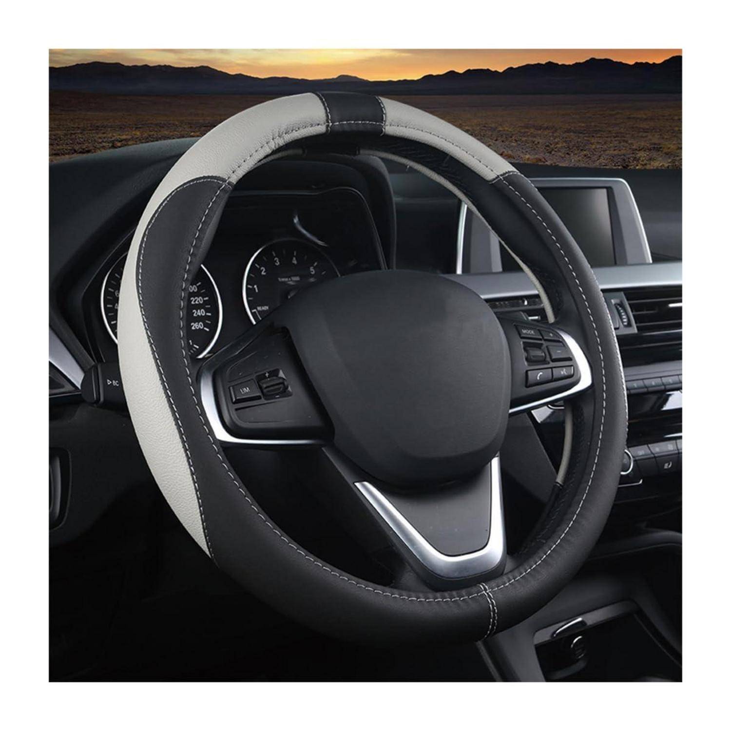 Nahaufnahme eines Autolenkrads mit Bedienelementen, Armaturenbrettinstrumenten und sichtbarem Infotainment-Bildschirm im Inneren des Fahrzeugs.