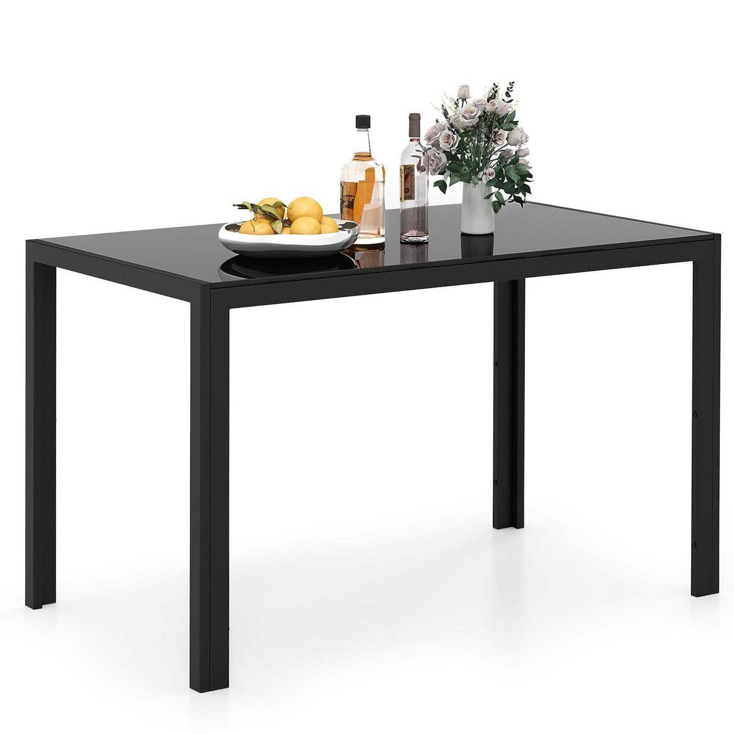 Schwarzer rechteckiger Esstisch mit vier Beinen, gezeigt mit einer Obstschale, Flaschen und einer Blumenvase oben.