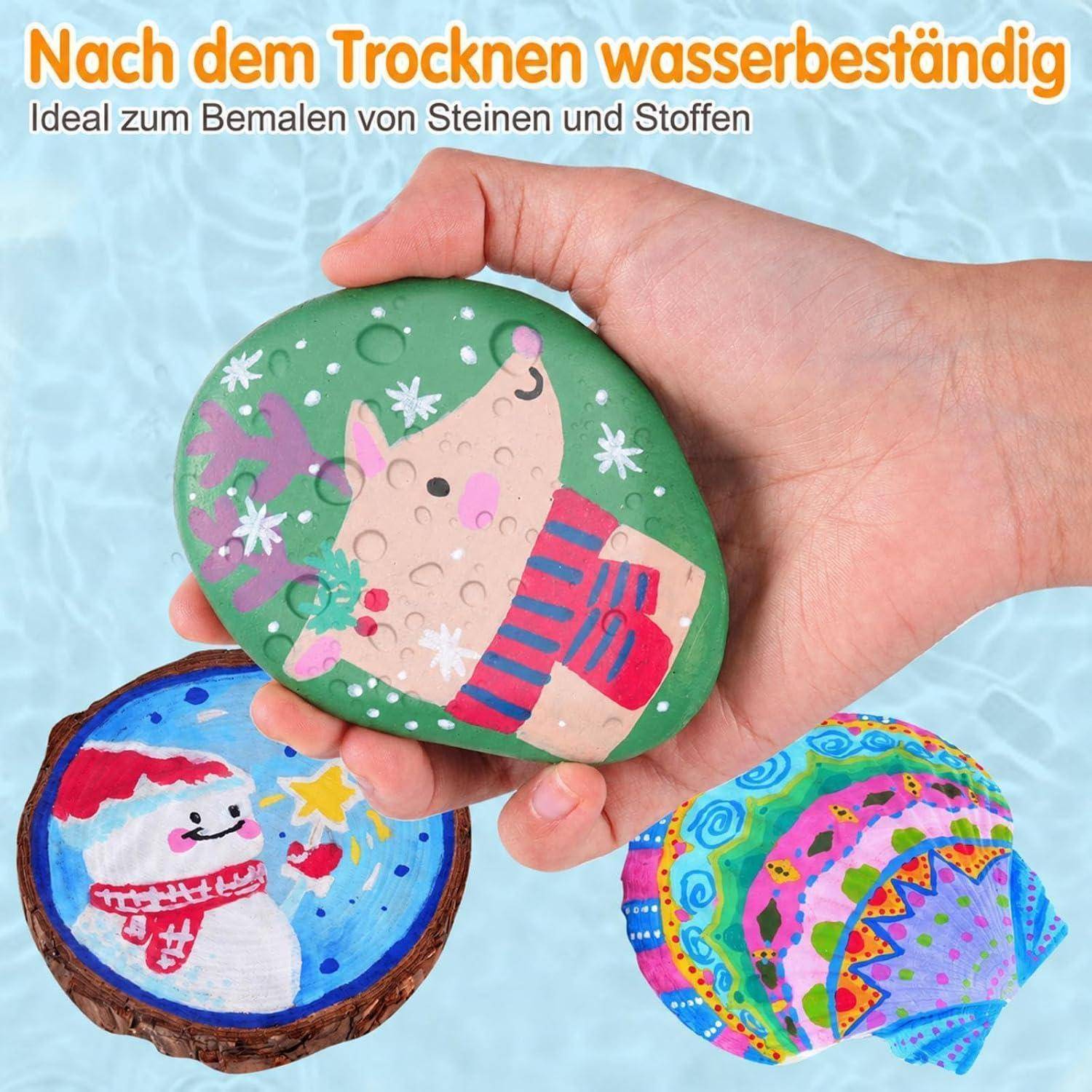 Hand hält ein bemaltes Felsenpuzzleteil mit einer Bärenillustration; andere farbenfrohe bemalte Steine zeigen das fertige Puzzledesign. Deutscher Text lautet „Nach dem Trocknen wasserbeständig