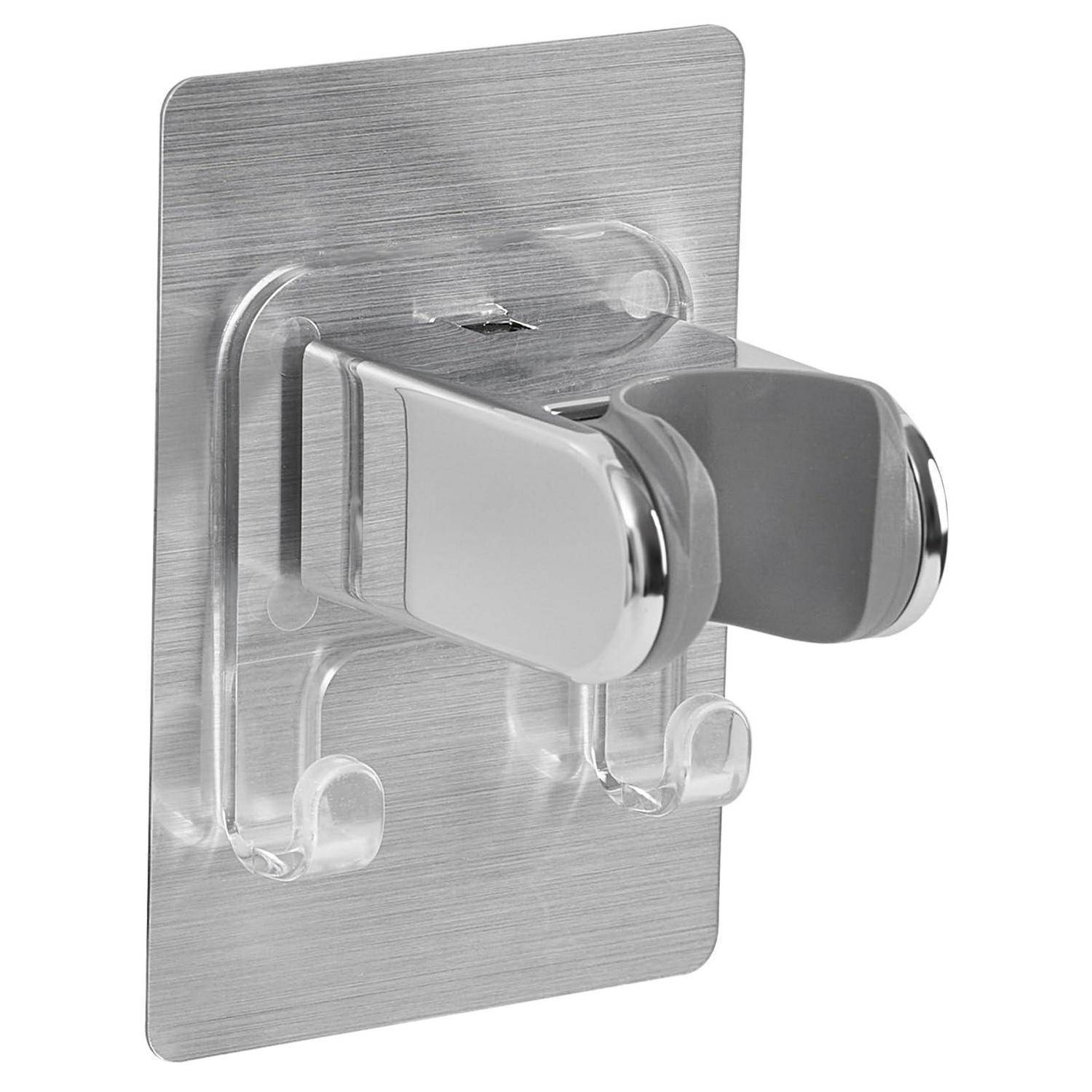 An der Wand befestigter transparenter Kunststoffhalter mit silbernem Metallrücken und zwei verchromten Clips, von vorne auf weißem Hintergrund gezeigt.