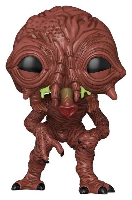Eine stilisierte braune außerirdische Kreaturfigurine mit einem großen runzligen Kopf, übergroßen schwarzen Augen und einem kleinen roten Mund steht frontal ausgerichtet.