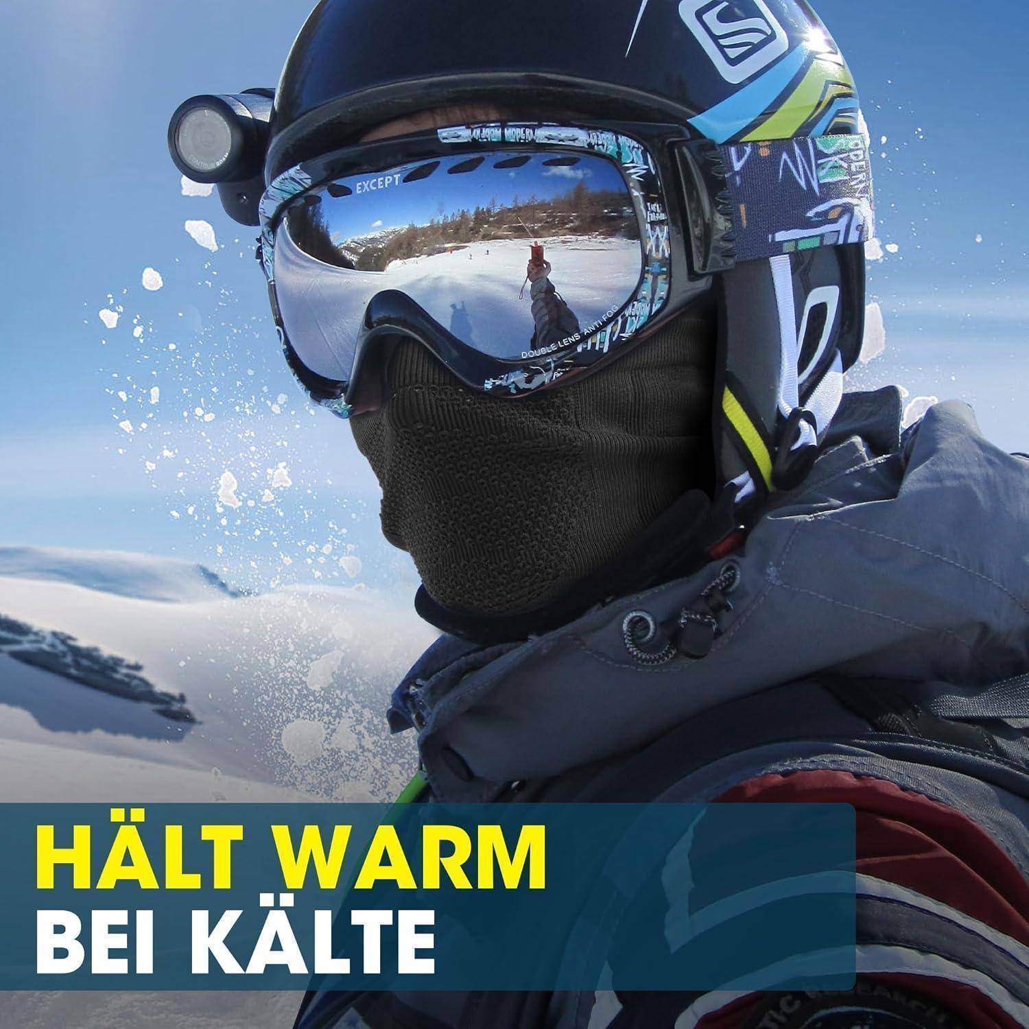 Wintersportaufnahme einer Person mit Helm und Schutzbrille im Schnee, mit dem deutschen Text „HÄLT WARM BEI KÄLTE